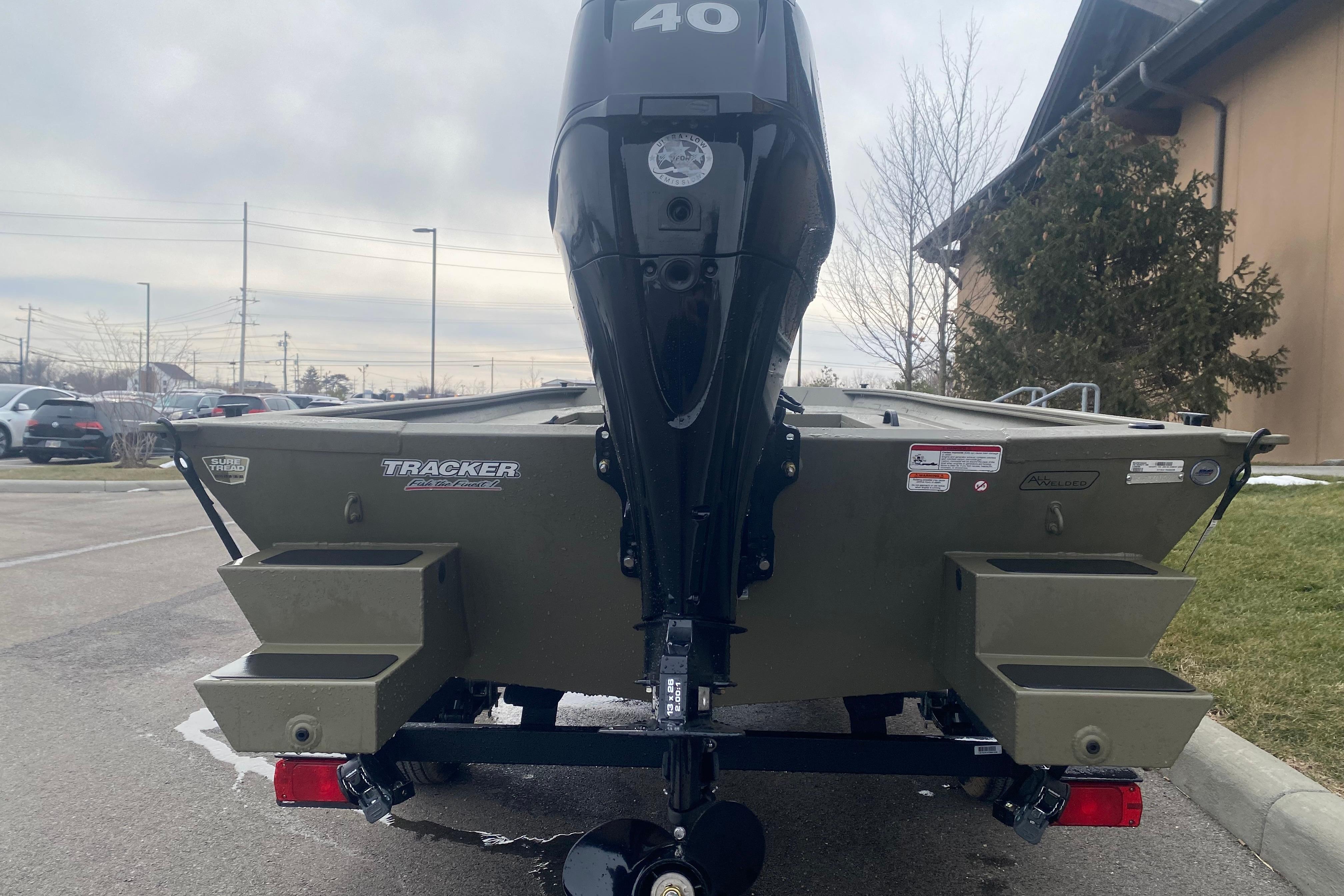 2026 Tracker Grizzly 1654 T Sportsman boat with 40 HP motor in parking lot.