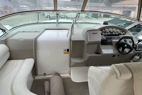 2002 Cruisers Yachts 3372 Express cockpit with steering wheel and dashboard controls.