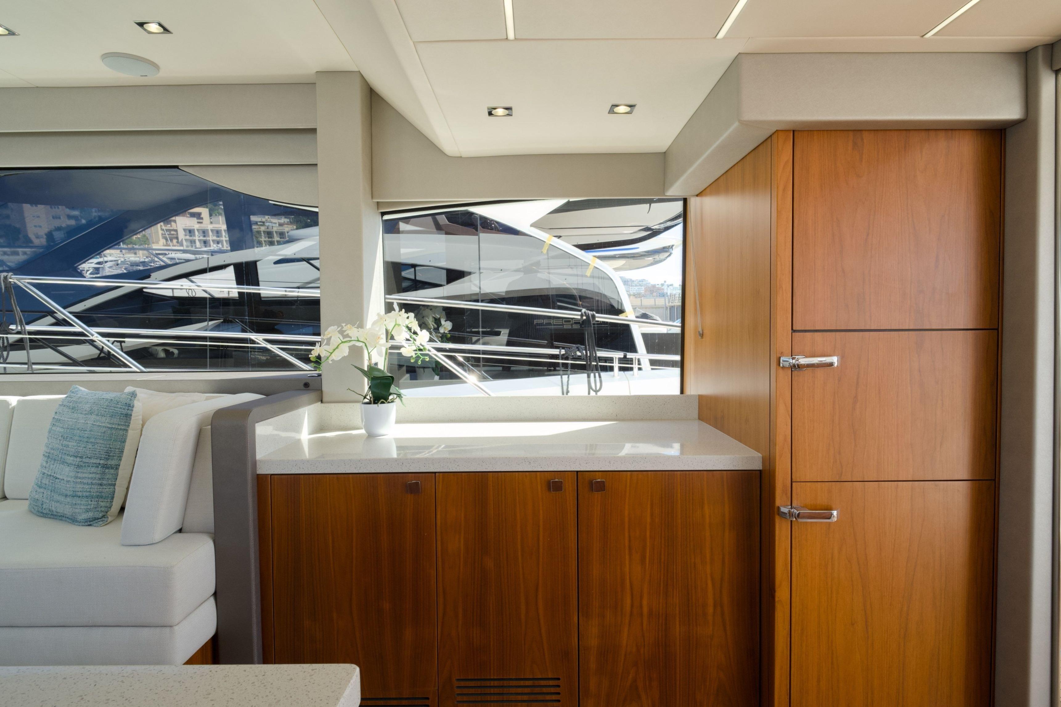 Luxurious interior of 2019 Sunseeker Manhattan 52 yacht with elegant wood cabinetry.