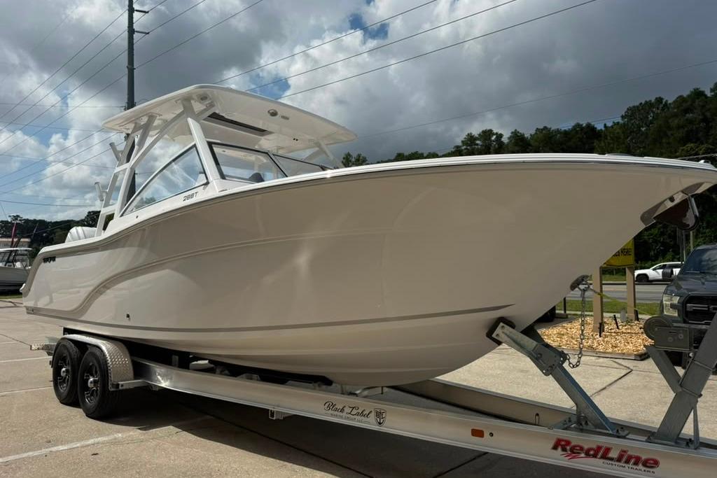 2026 Sea Fox 288 Traveler boat on trailer under cloudy sky.