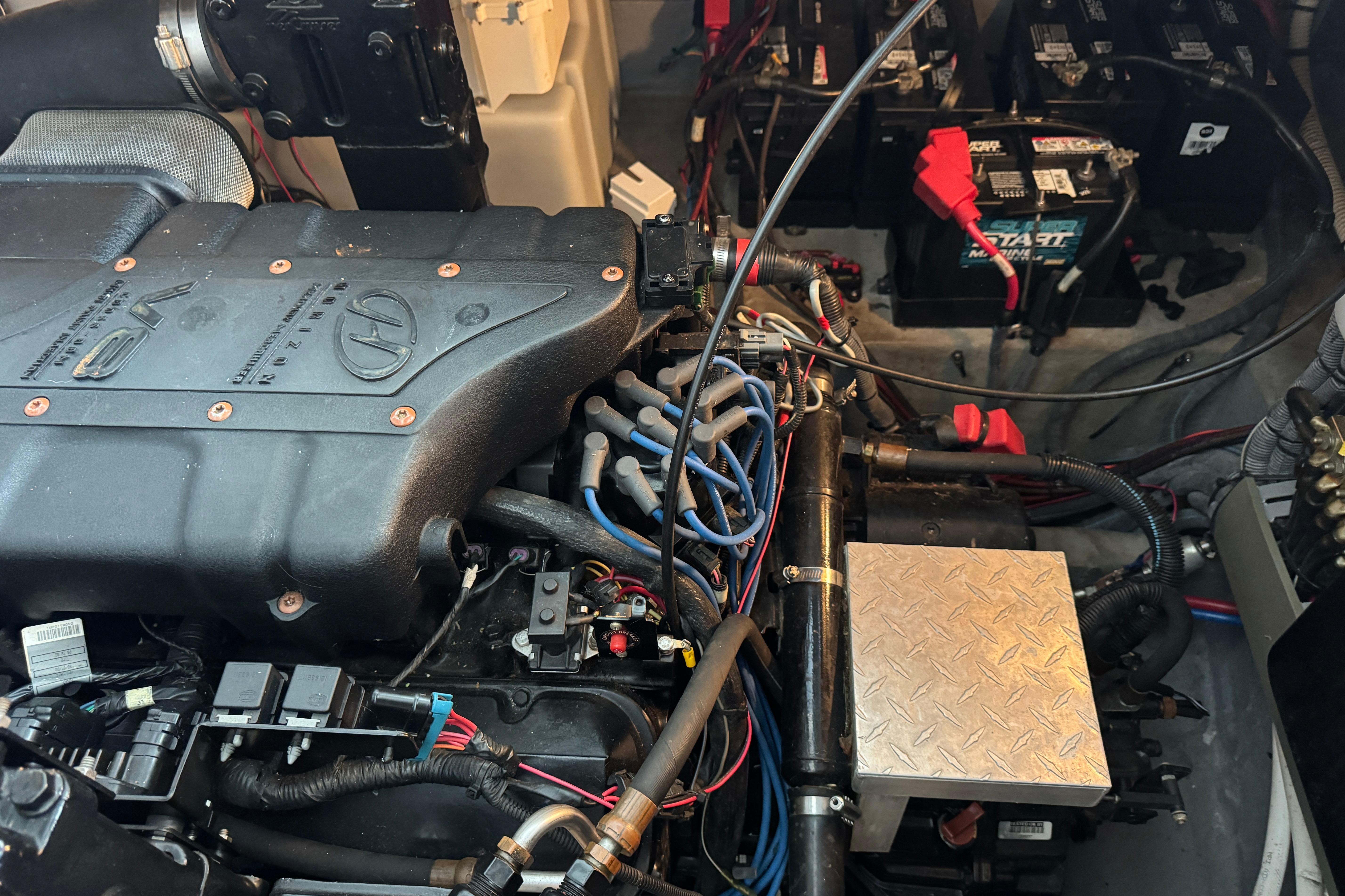 Engine compartment of a 2001 Sea Ray 380 Sundancer with visible wiring and battery setup.
