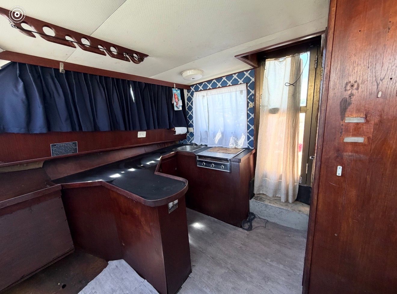 Interior of a 1973 Striker Sportfish boat with wooden furnishings.