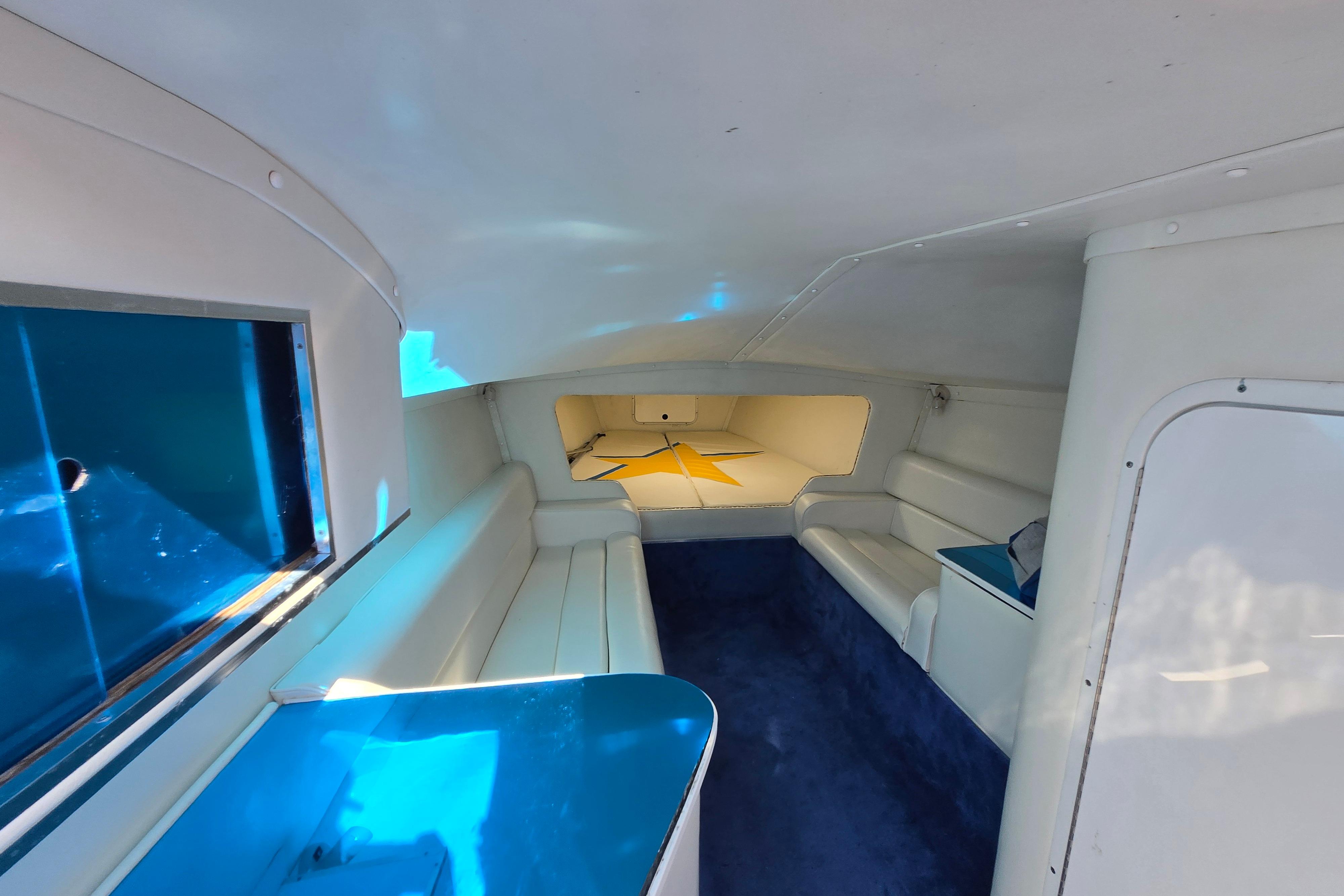 Interior of a 2002 Avanti 41 boat, featuring white seating and blue accents.