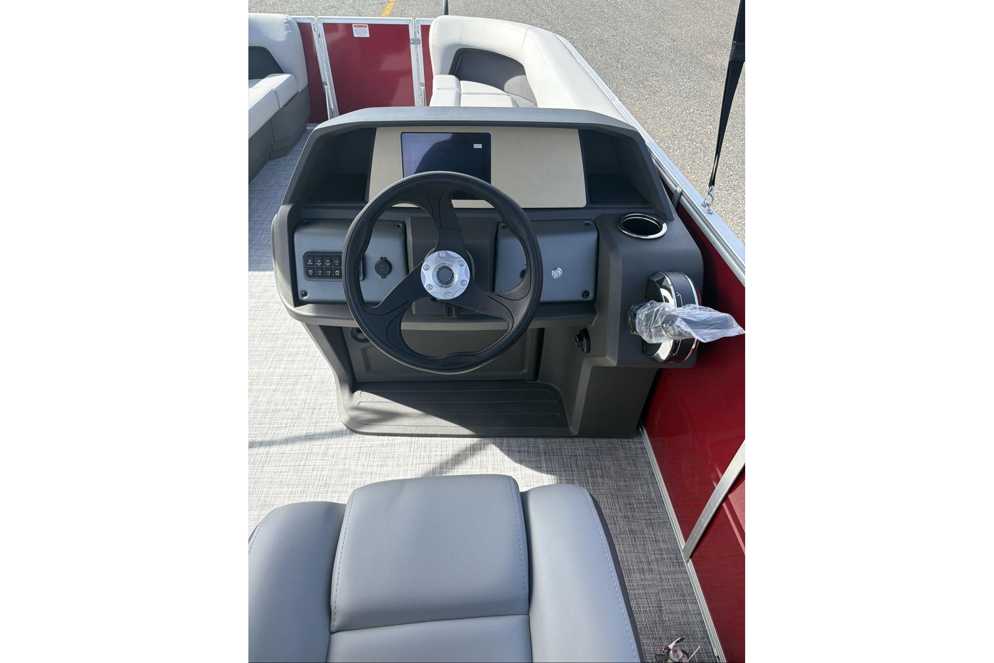 2026 Sun Tracker Party Barge 18 DLX steering console with modern controls and seating.