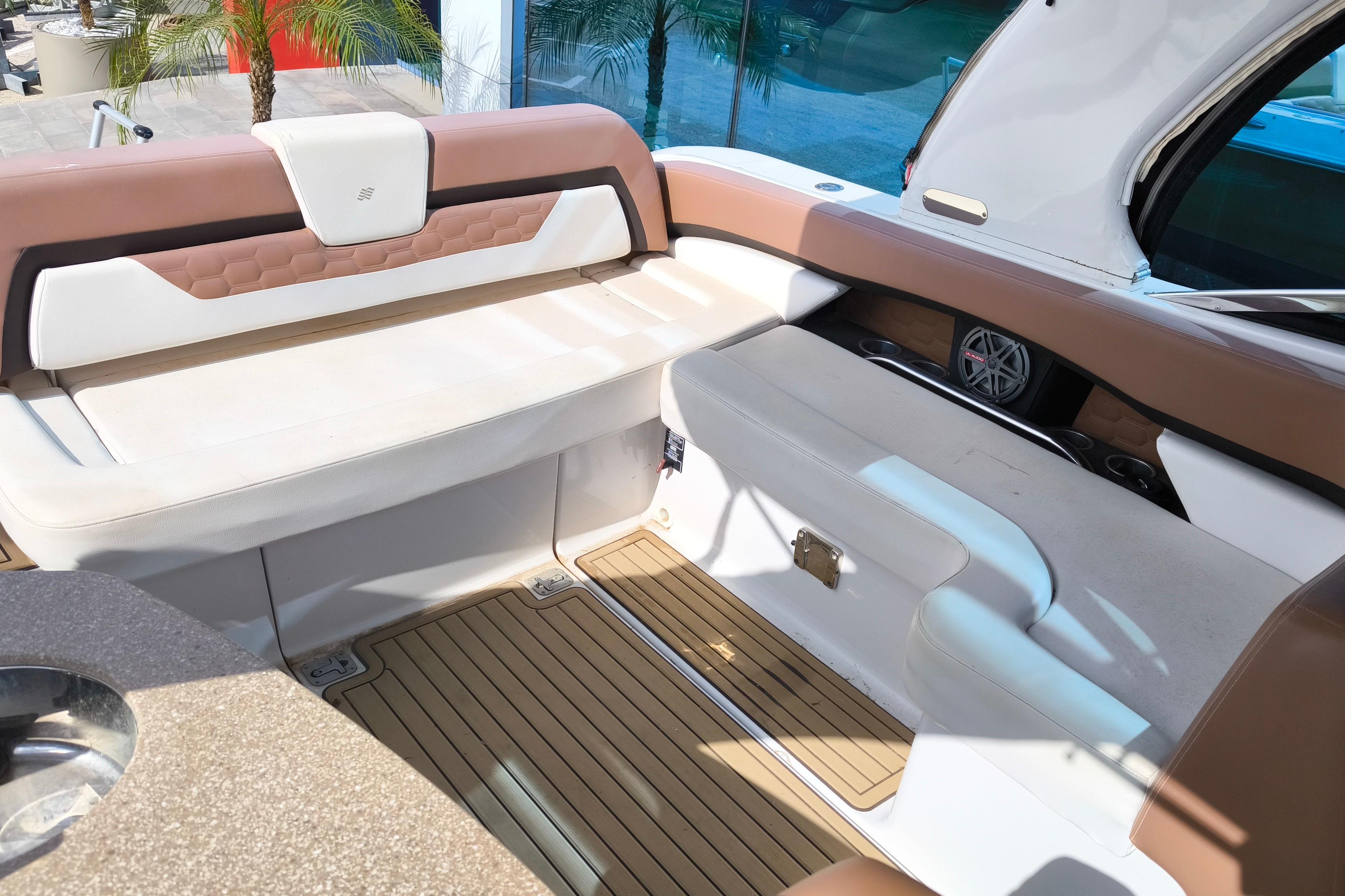 Interior seating of 2017 Four Winns H290 boat, featuring brown and white upholstery.