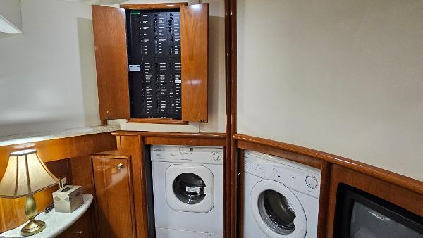 Laundry area in 2000 Carver 450 Voyager Pilothouse with washer, dryer, and electrical panel.