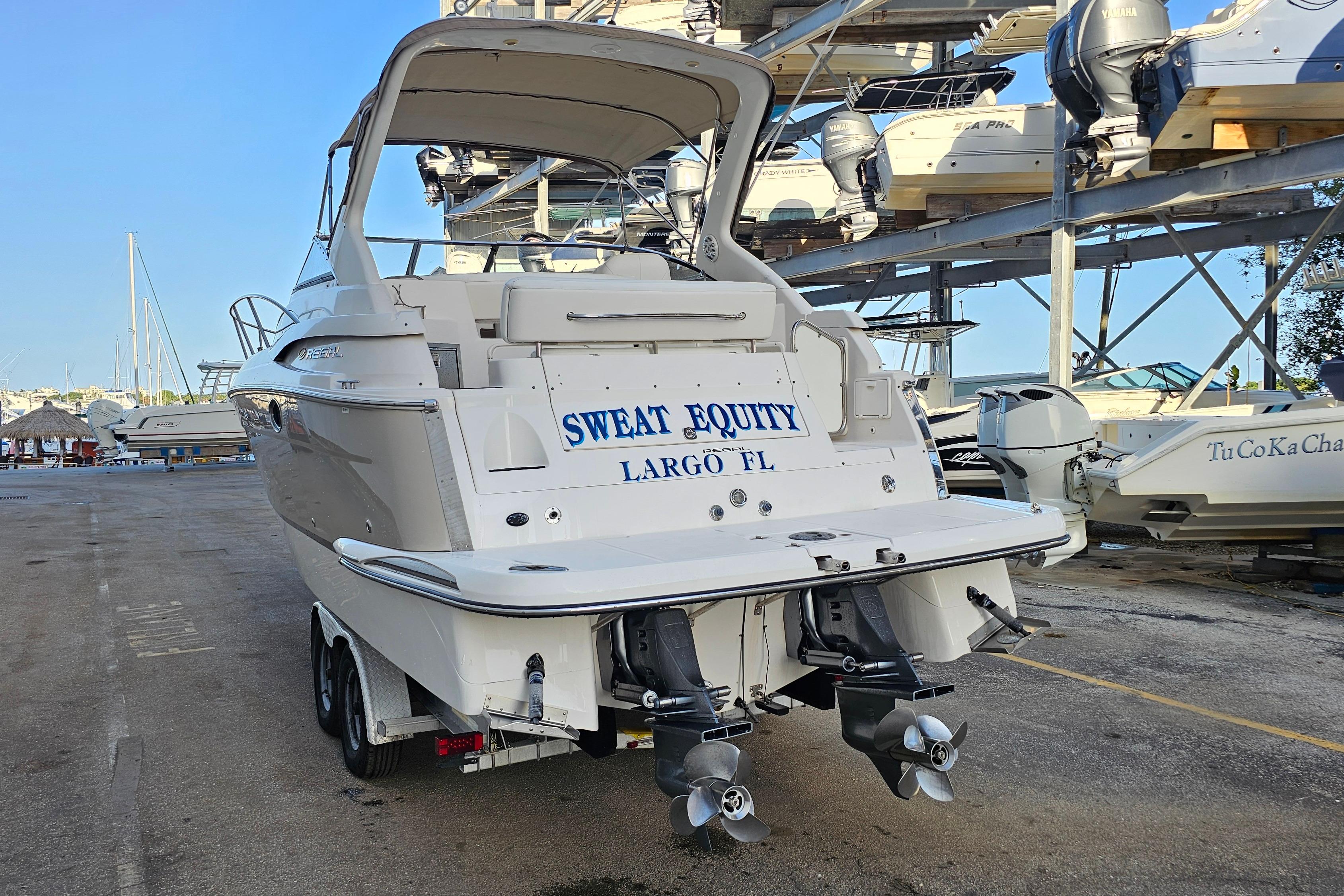 2005 Regal 3060 Window Express boat on trailer, labeled "Sweat Equity," in Largo, FL.