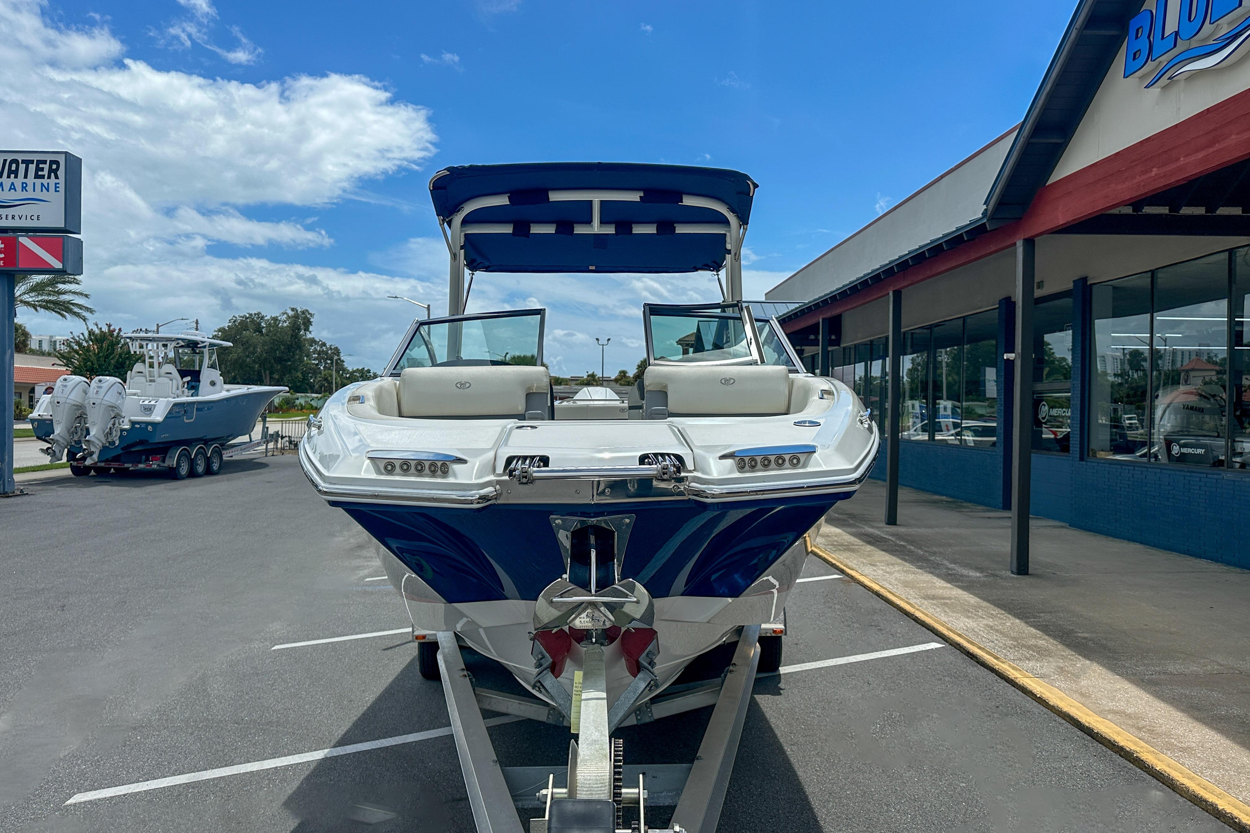 2022 Cobalt 25SC boat on trailer outside Bluewater Marine dealership.