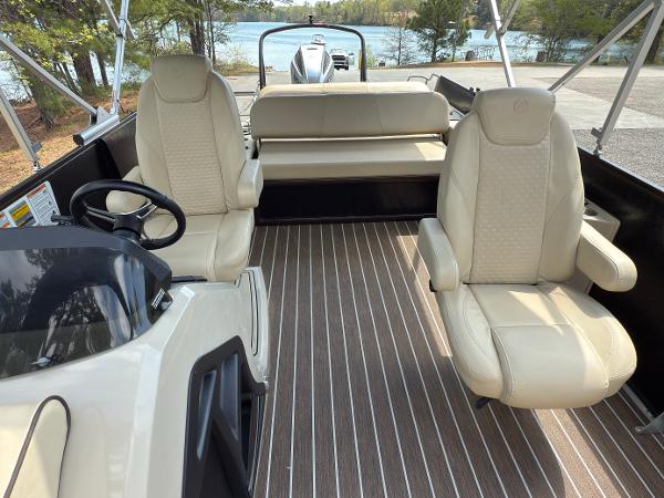 2022 Premier 250 Solaris boat interior with beige seating and striped flooring.