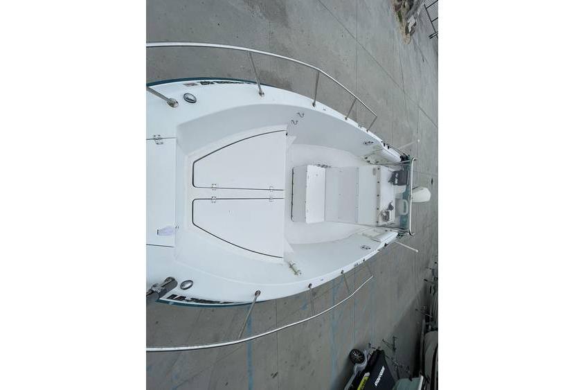 Overhead view of a 1998 Sunbird 230 CC boat on a concrete surface.