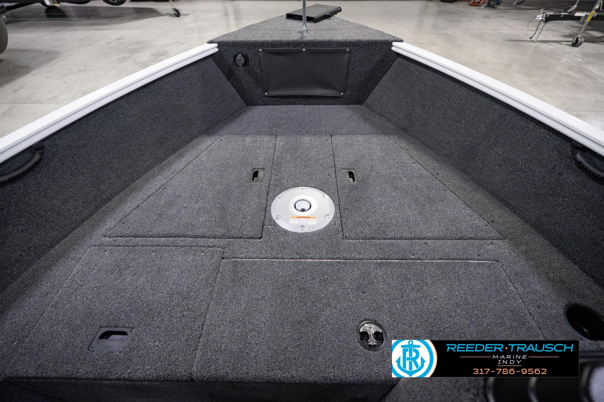 2026 Lund 1650 Rebel XL SS boat interior with carpeted deck and storage compartments.