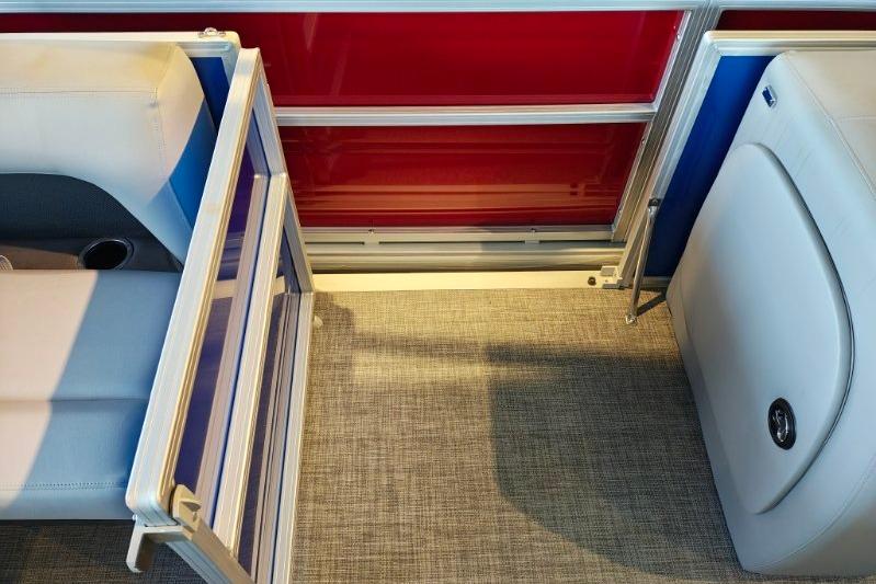 Interior view of 2026 Sun Tracker Party Barge 18 DLX, featuring seating and red paneling.