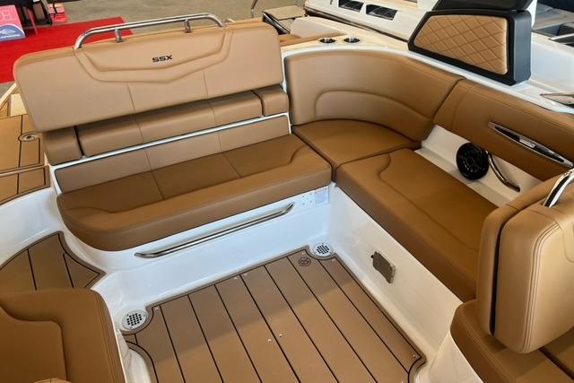 Luxurious interior of 2025 Chaparral 247 SSX boat with tan leather seating.