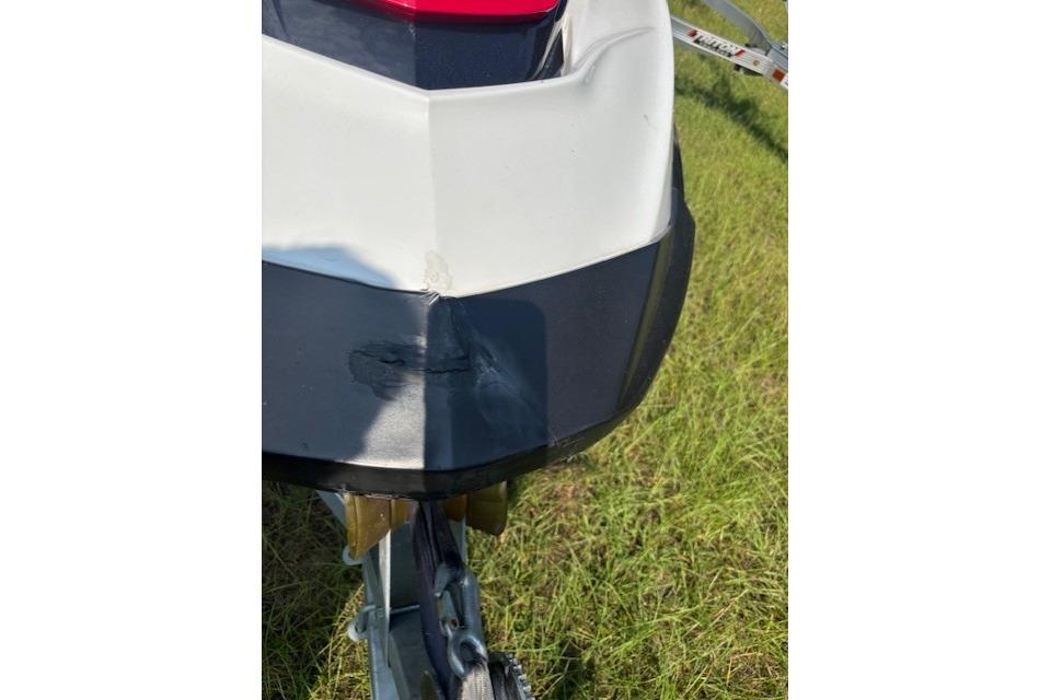 2010 Sea-Doo GTX 155 jet ski with visible hull damage on grass.