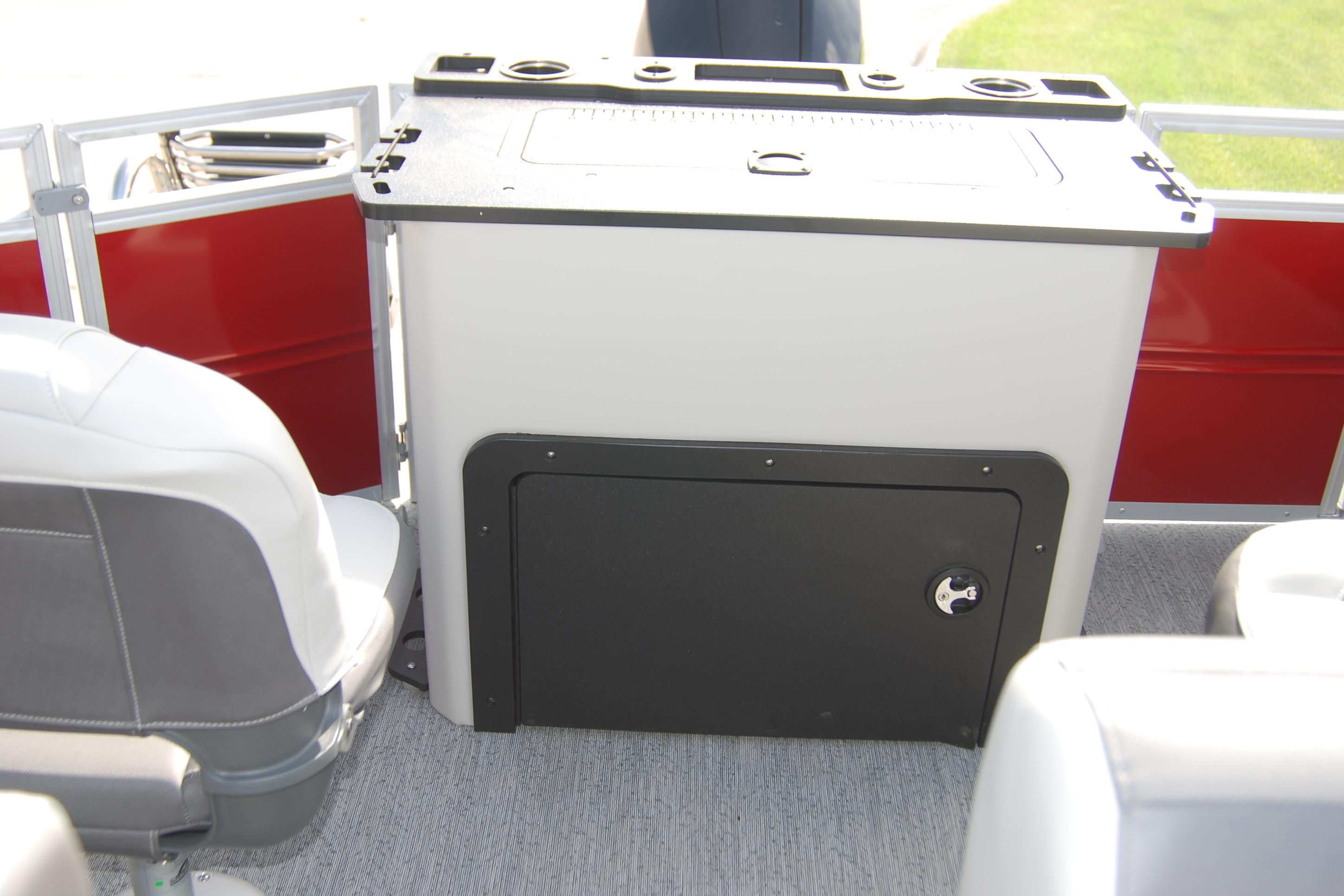 Interior of 2026 Sun Tracker Fishin' Barge 22 XP3, featuring seating and storage area.