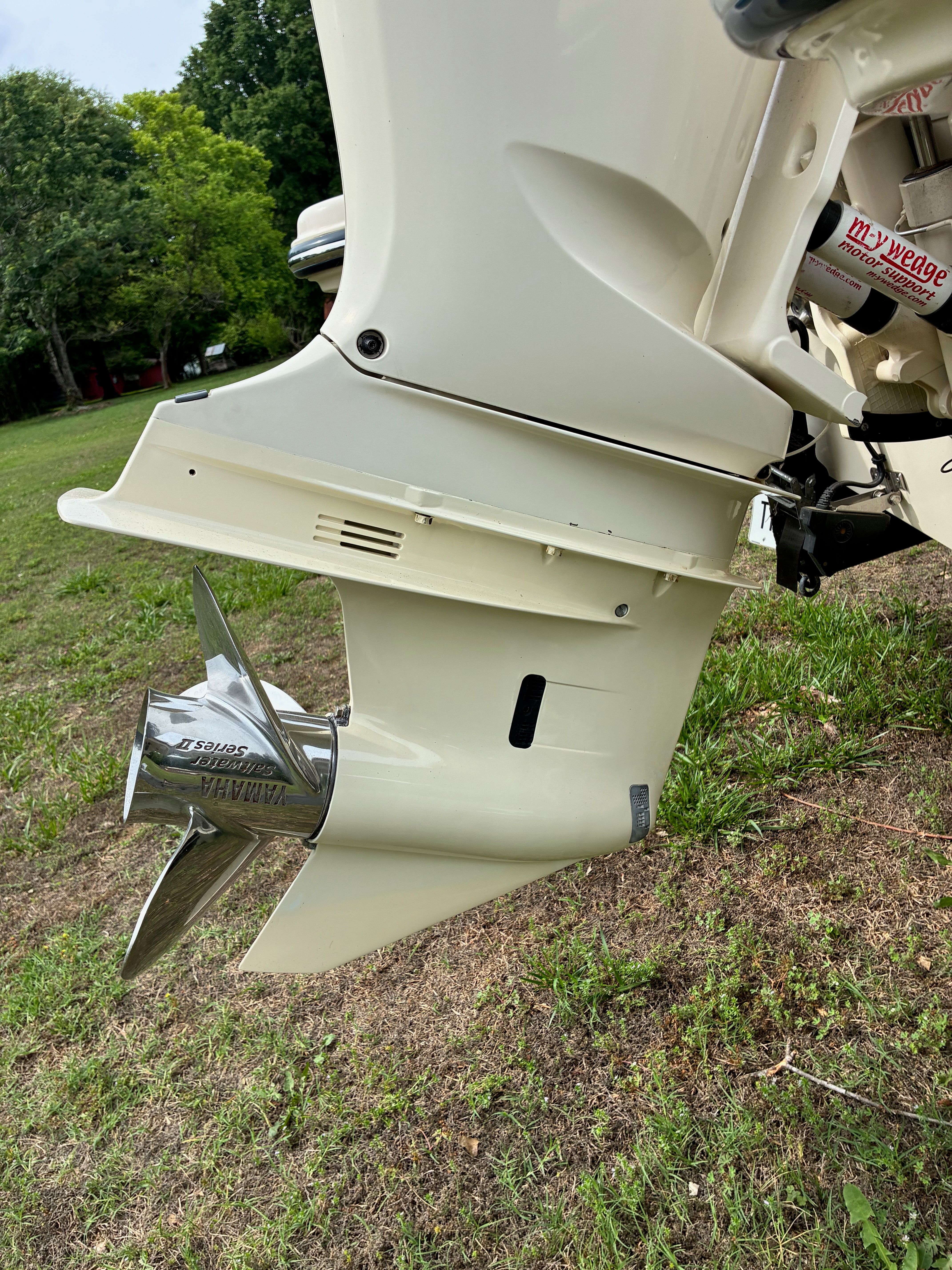 2018 Grady-White Freedom235 outboard motor on grassy area.