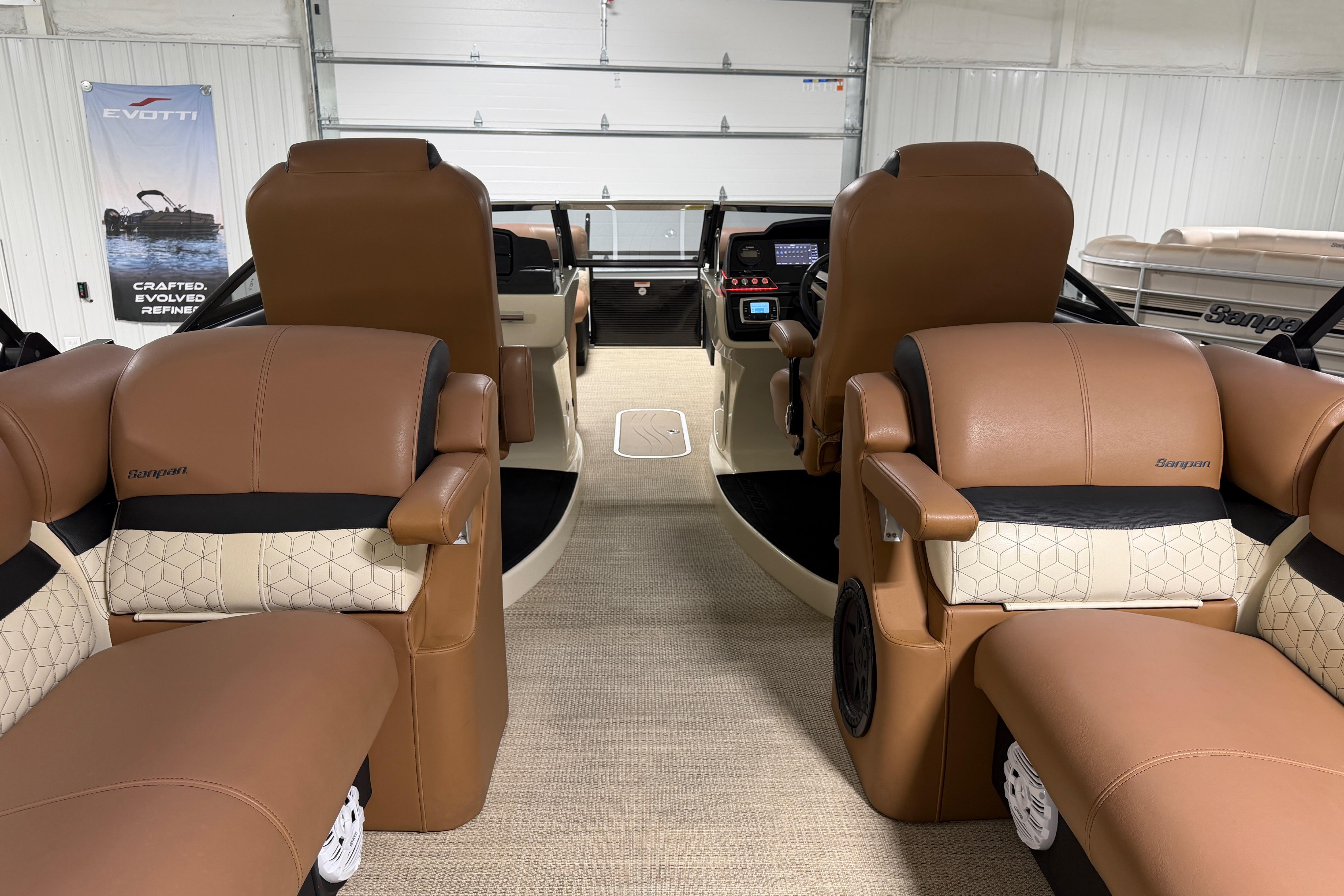2018 Godfrey Sanpan 2500 ULC pontoon boat interior with luxurious tan seating and modern dashboard.