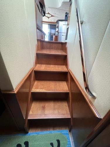 Wooden staircase inside a 2009 Ovation 52 yacht.