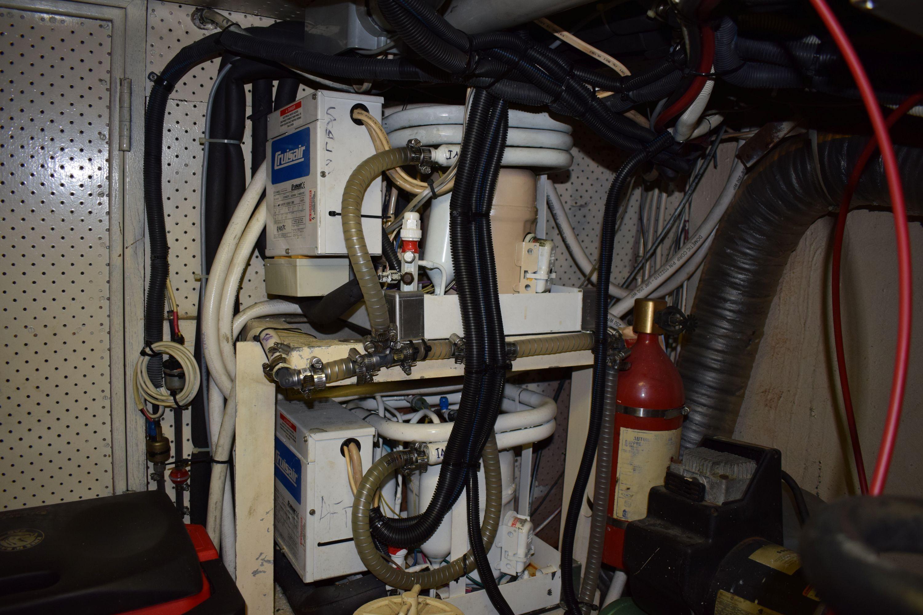 Engine room of a 1980 Cheoy Lee 52 Motorsailer with mechanical equipment and wiring.
