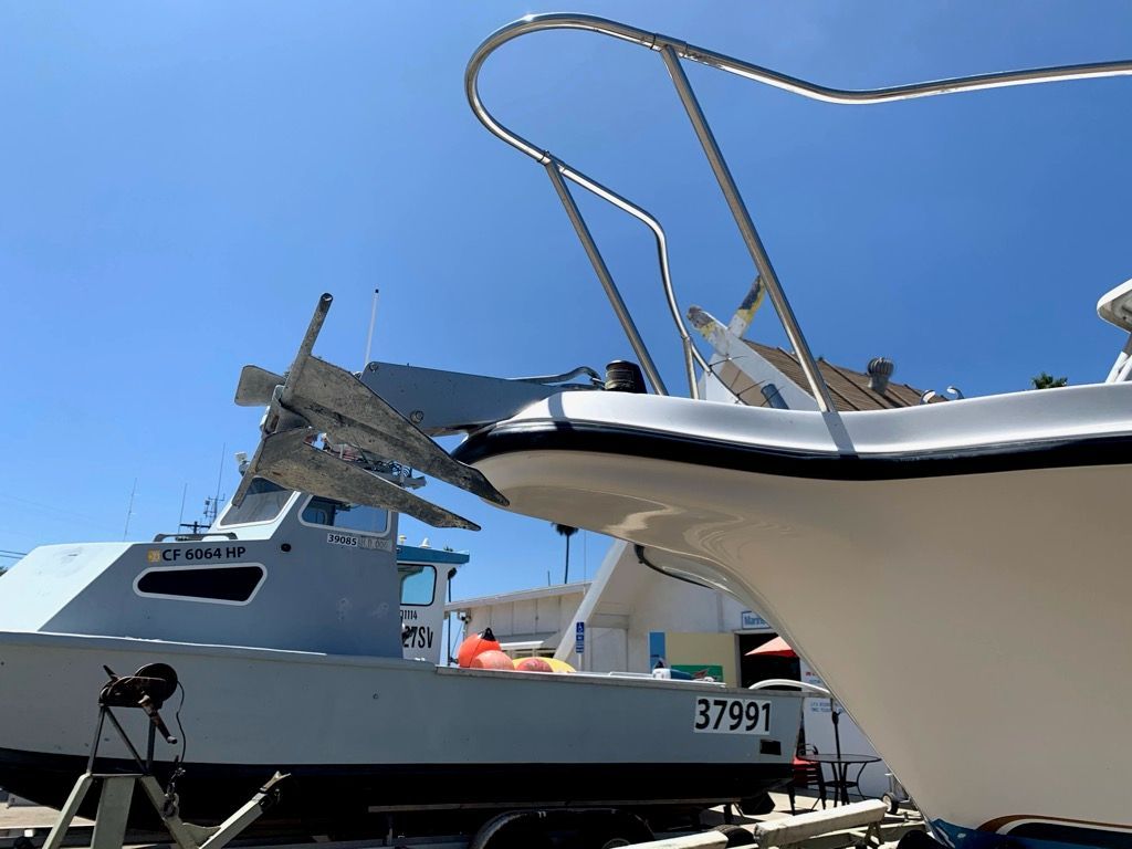 A 2003 Bayliner Walk Around Cuddy Cabin boat is on a trailer outdoors.