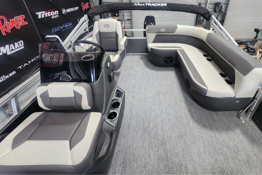 Interior of 2026 Sun Tracker Bass Buggy 16 DLX pontoon boat with seating and console.