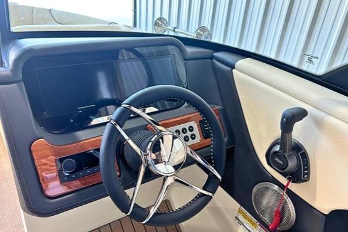 2025 Chris-Craft Sportster 25 dashboard with steering wheel and control panel.