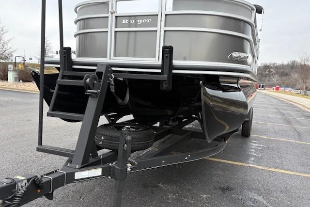2025 Ranger Reata 243C pontoon boat on trailer, parked in a lot.