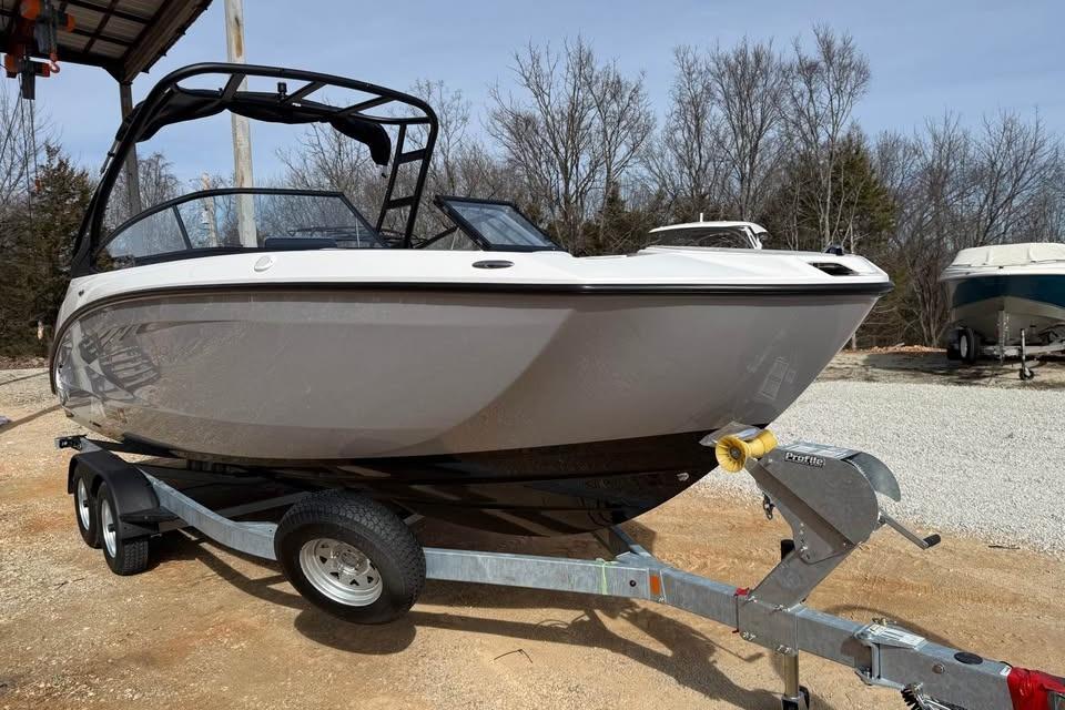 2026 Yamaha Boats AR250 on trailer, parked outdoors, showcasing sleek design and modern features.
