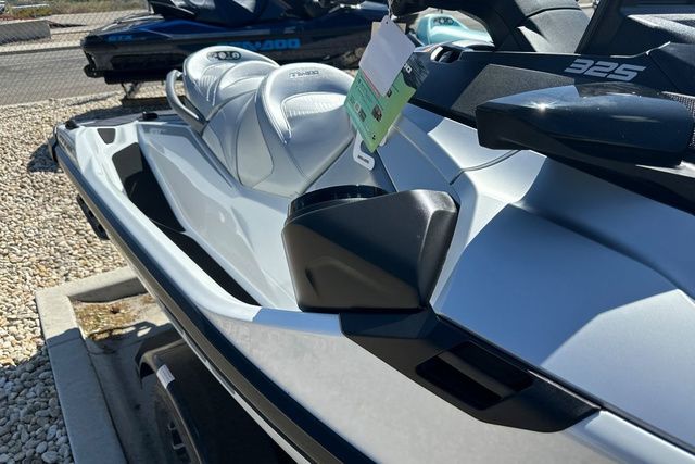 A modern Sea-Doo jet ski with sleek white seats and a black handlebar.