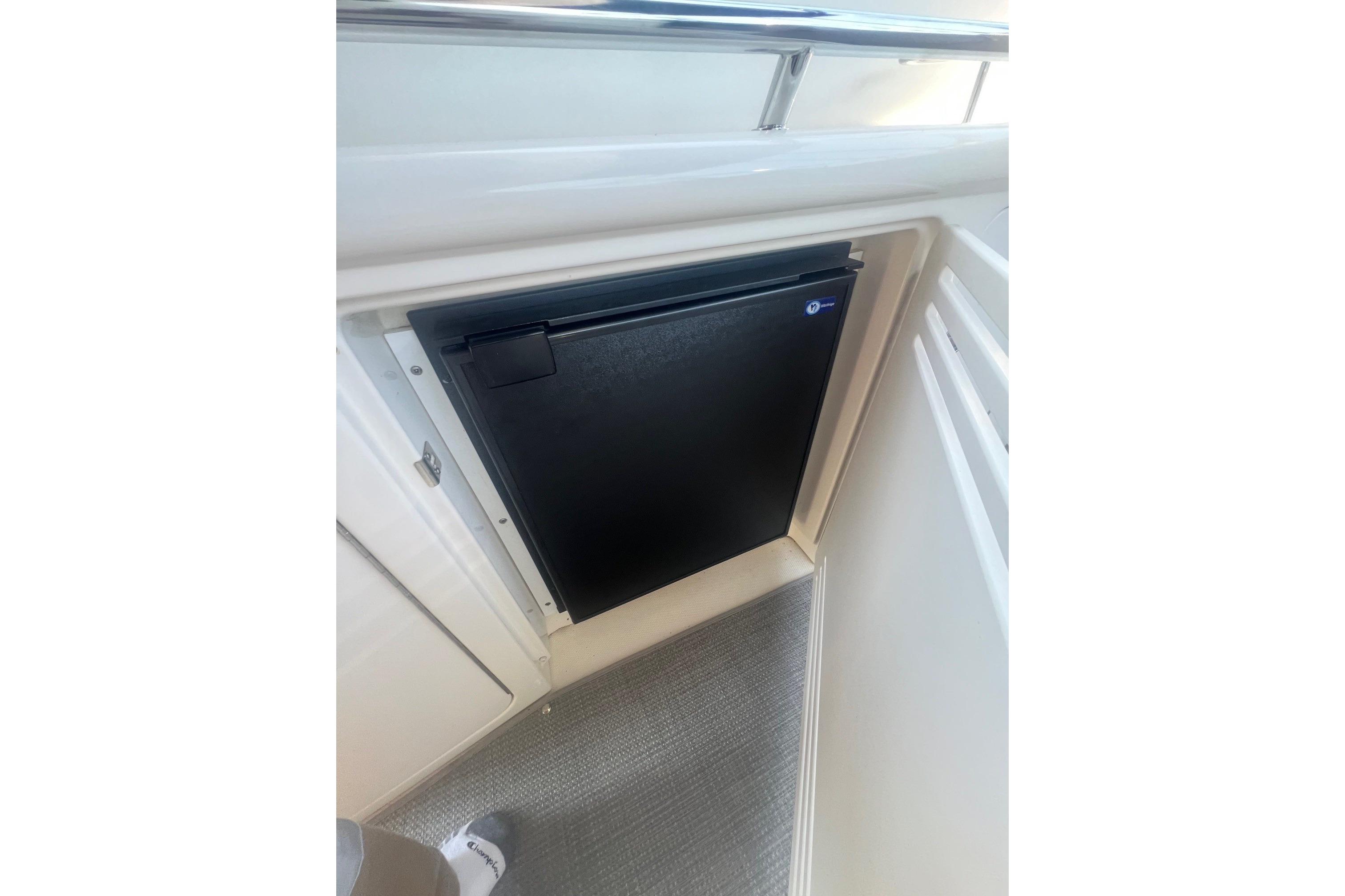 Compact refrigerator on 2005 Sea Ray 360 Sundancer yacht interior.