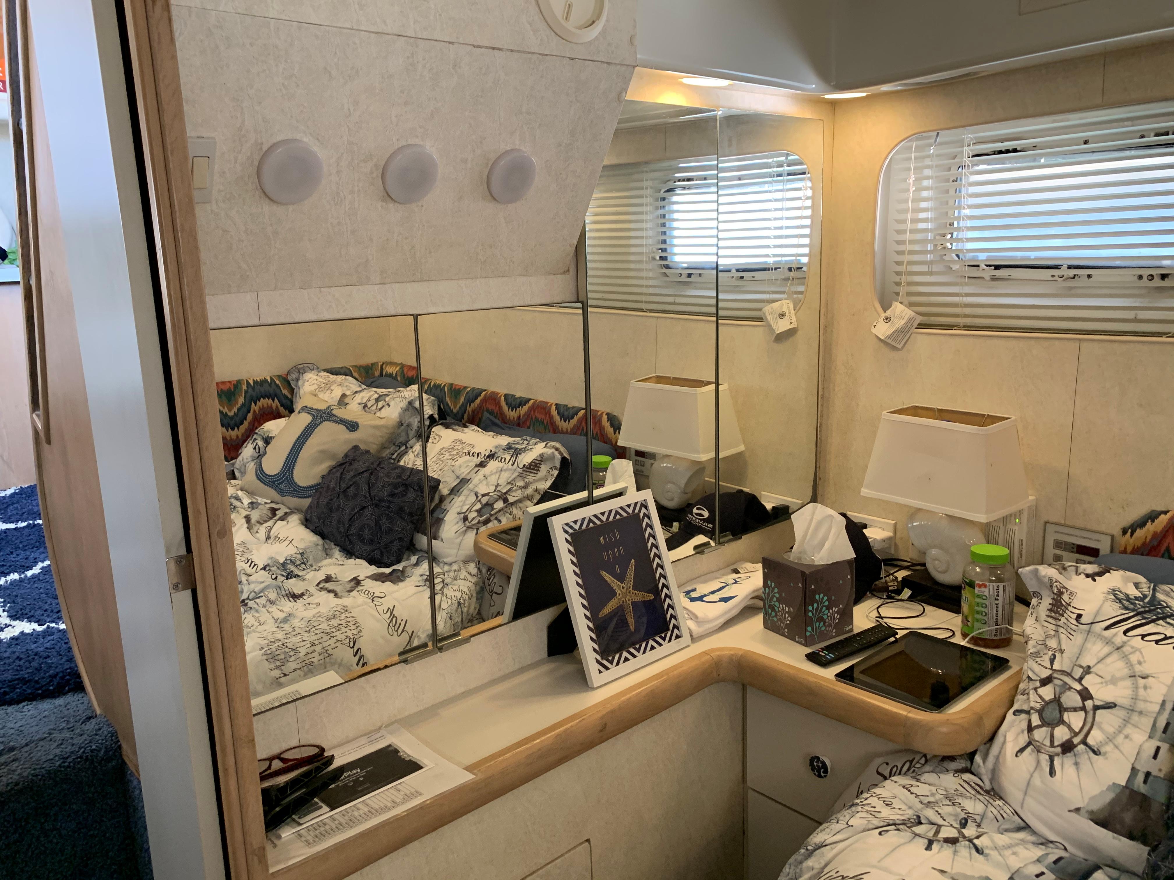 Interior of 1992 Silverton 34 Aft Cabin Motor Yacht with cozy bedroom and nautical decor.