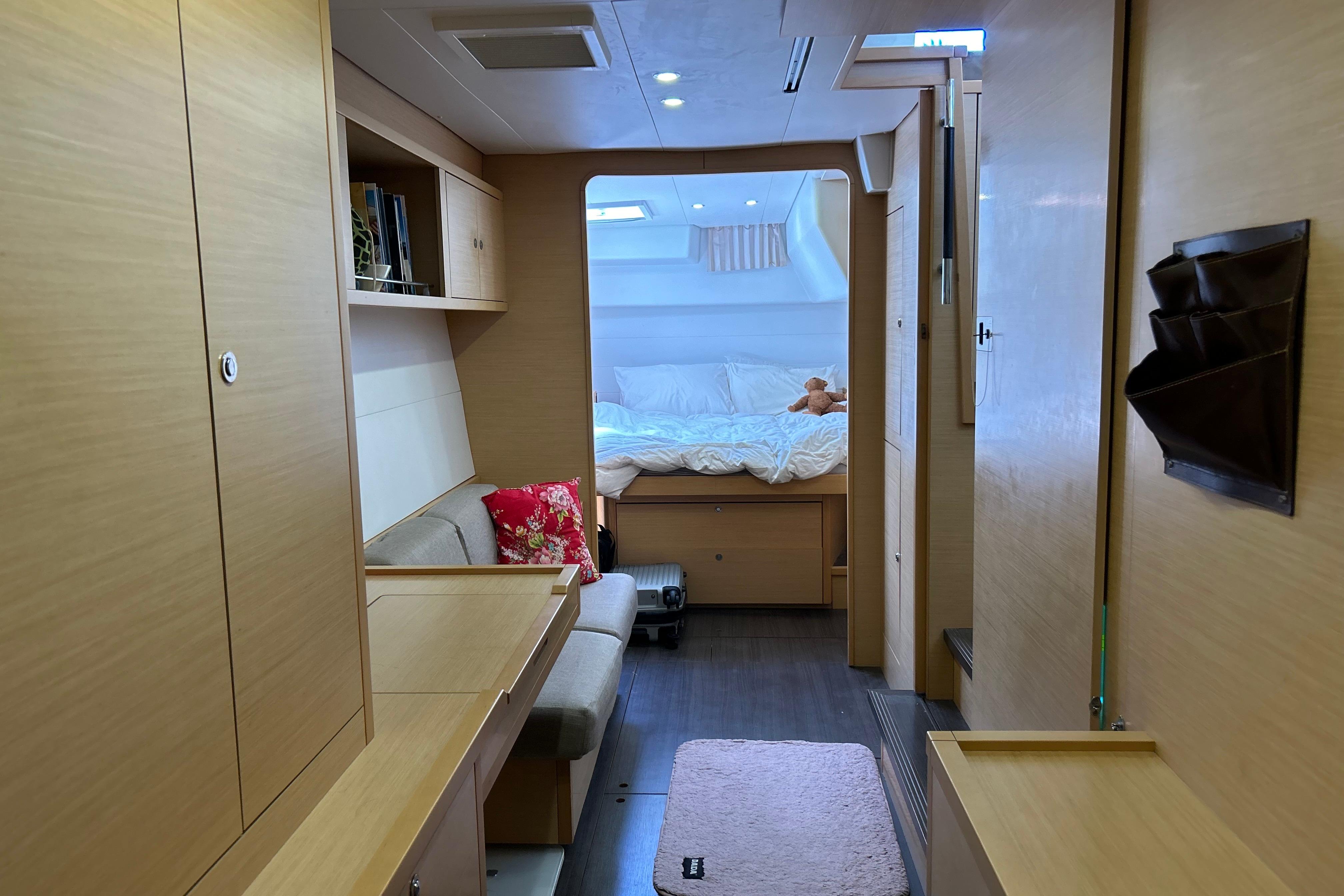 Interior of 2012 Lagoon 450 F catamaran with cozy bedroom and modern furnishings.