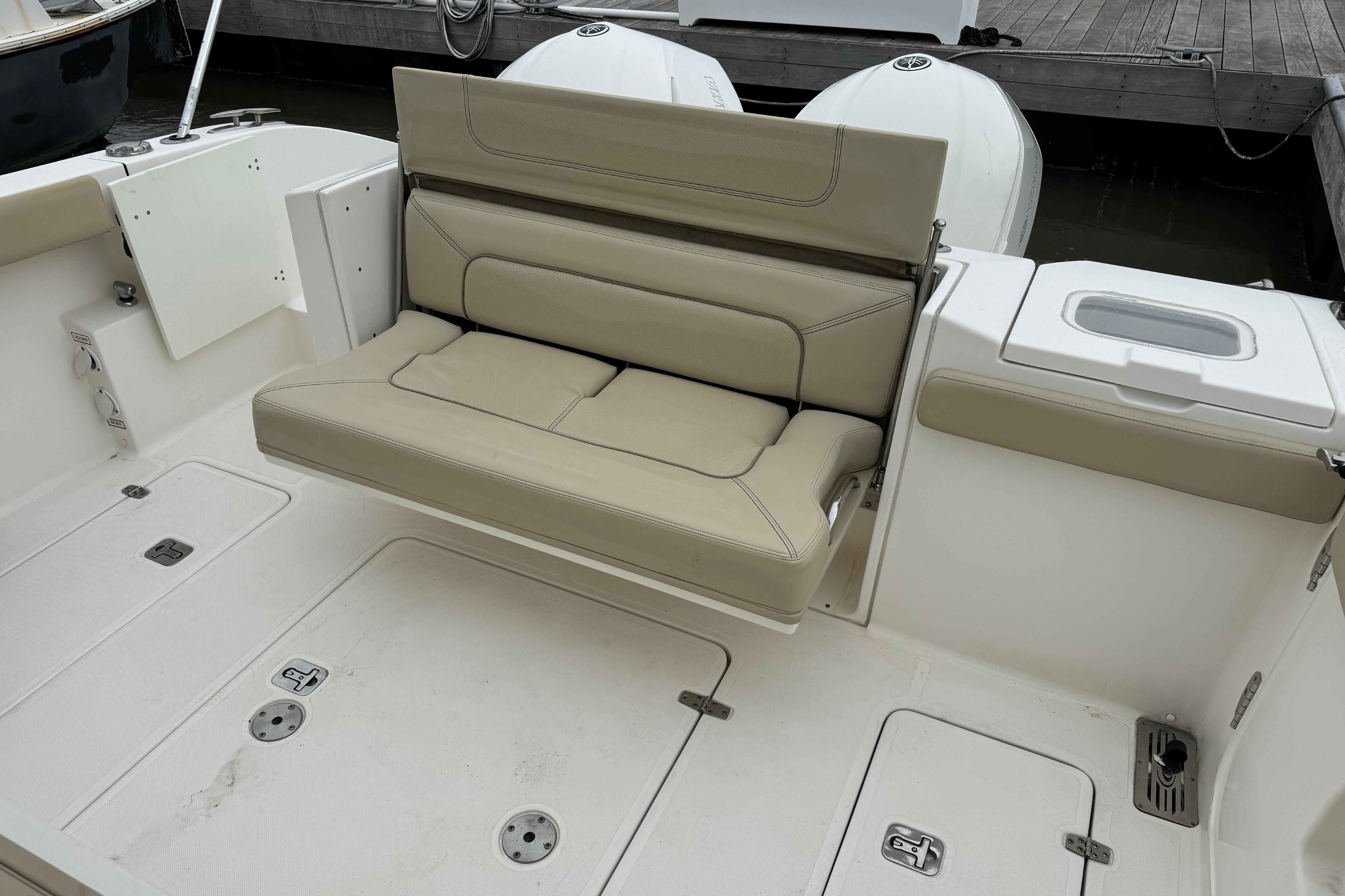 2018 Pursuit S 328 Sport boat with beige seating and storage compartments.