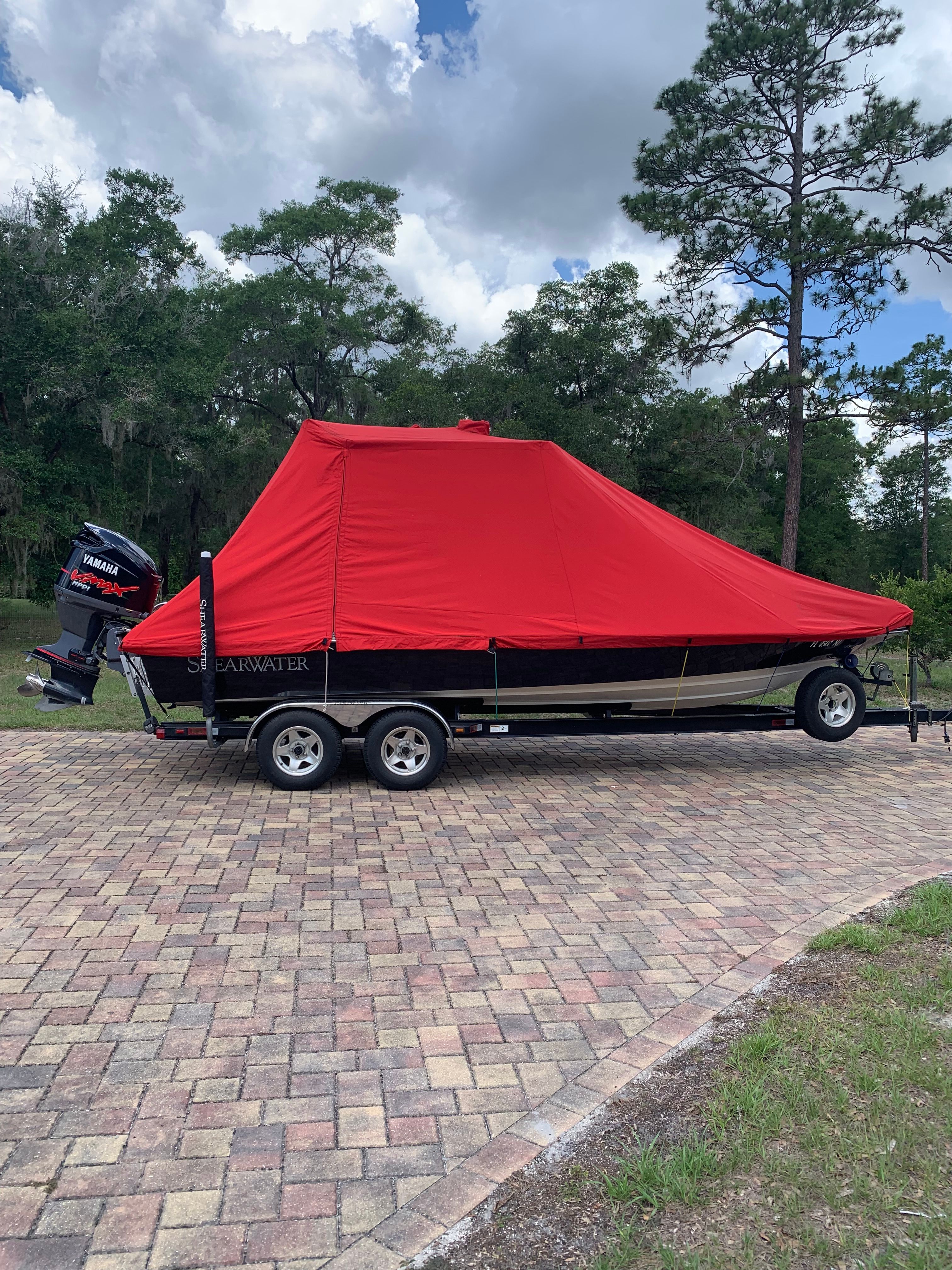 2007 ShearWater 23 LTZ boat with red cover on trailer.