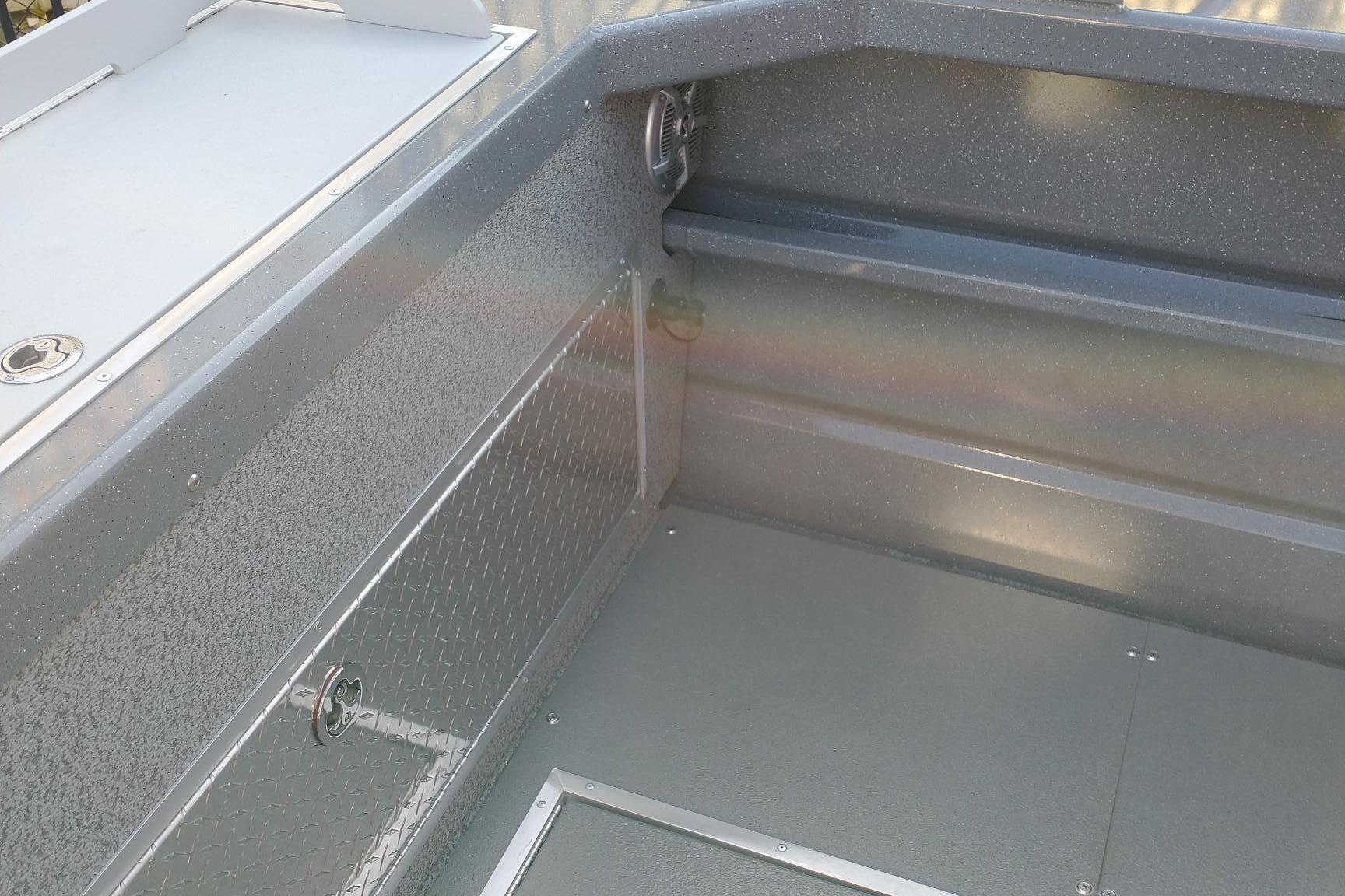 2024 Spartan 220 Maximus Pro interior with textured metal finish and storage compartment.