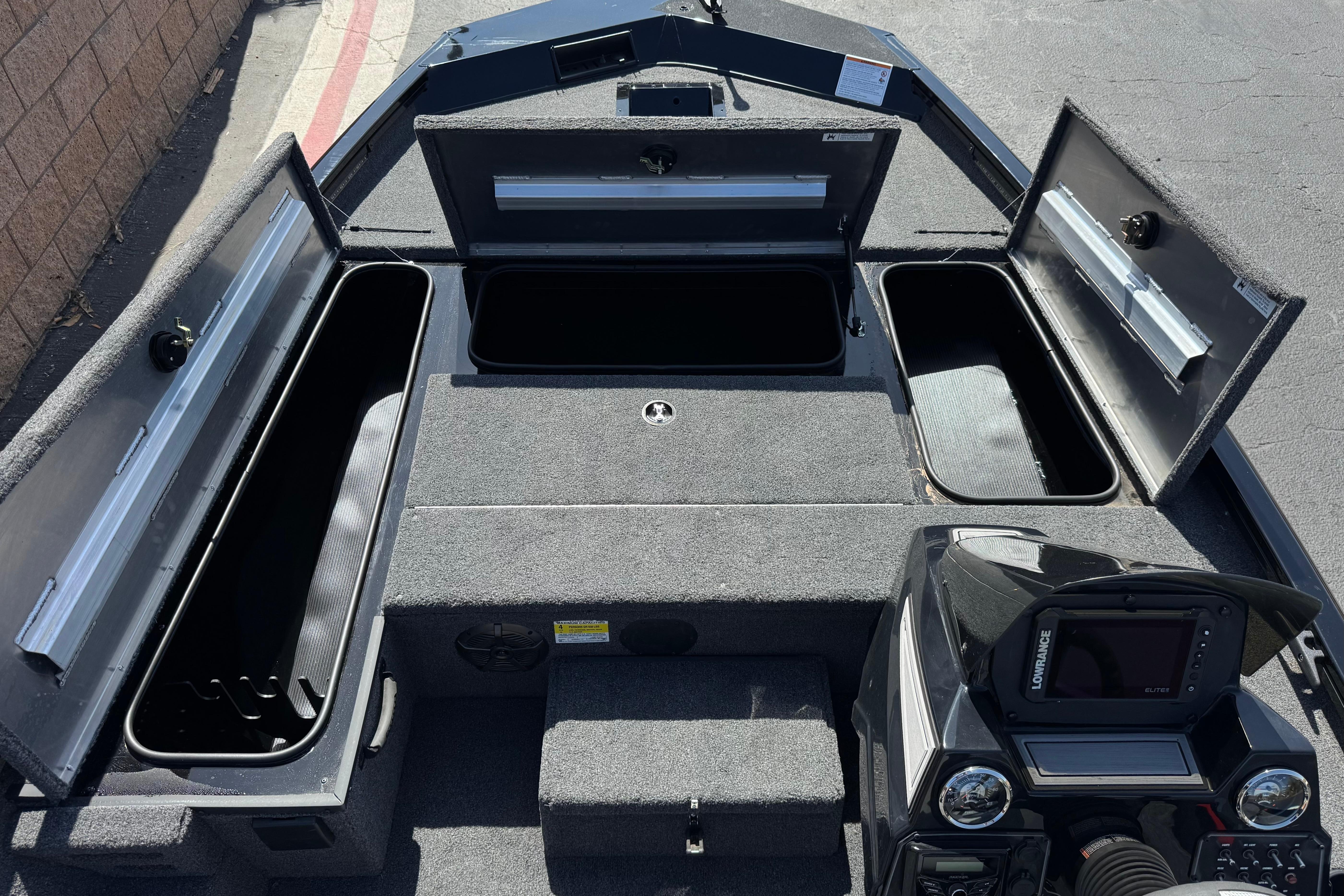 2024 Lowe Stinger 175 boat interior with open storage compartments and control panel.