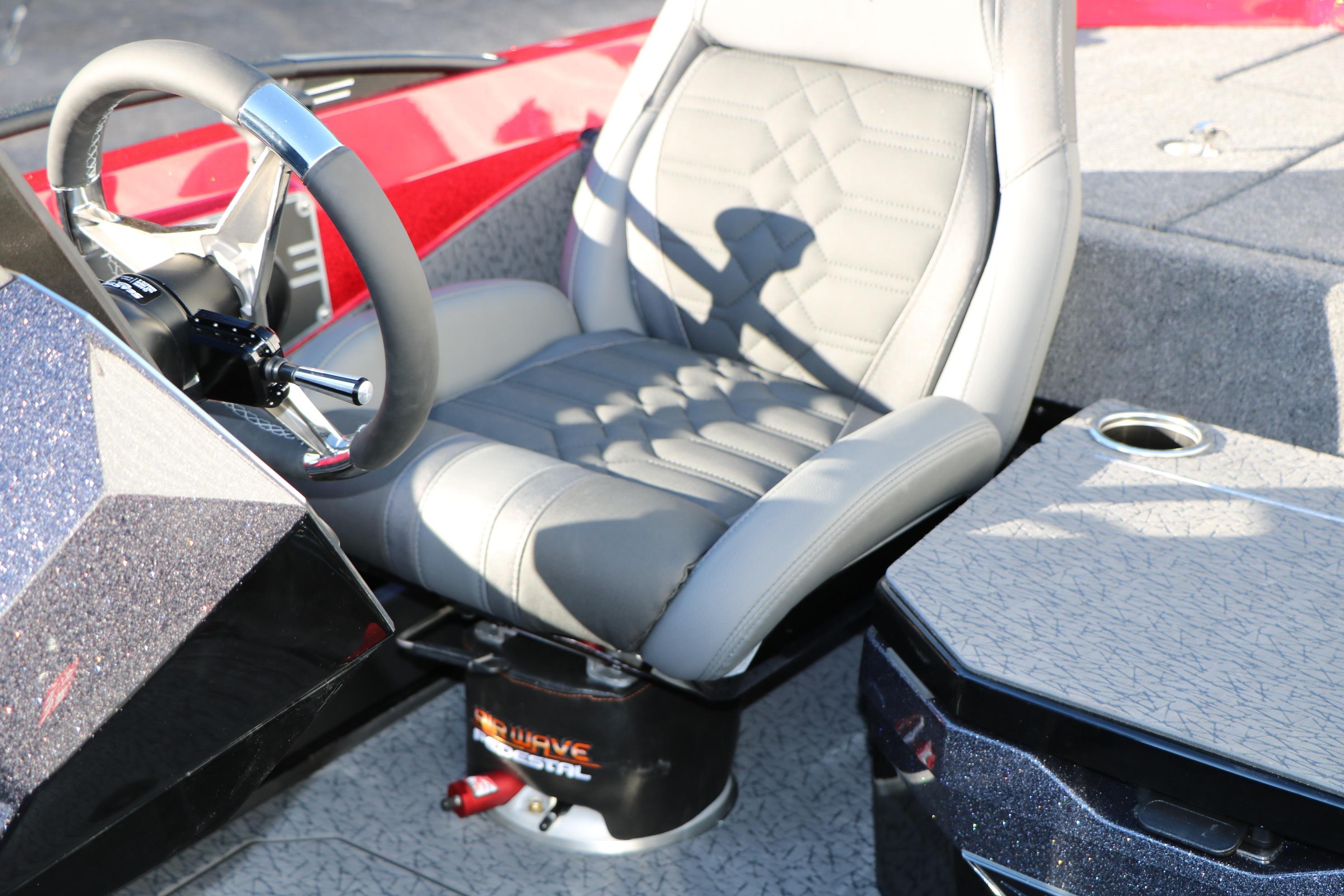 2026 Vexus VXs21 boat interior with gray captain's seat and steering wheel.