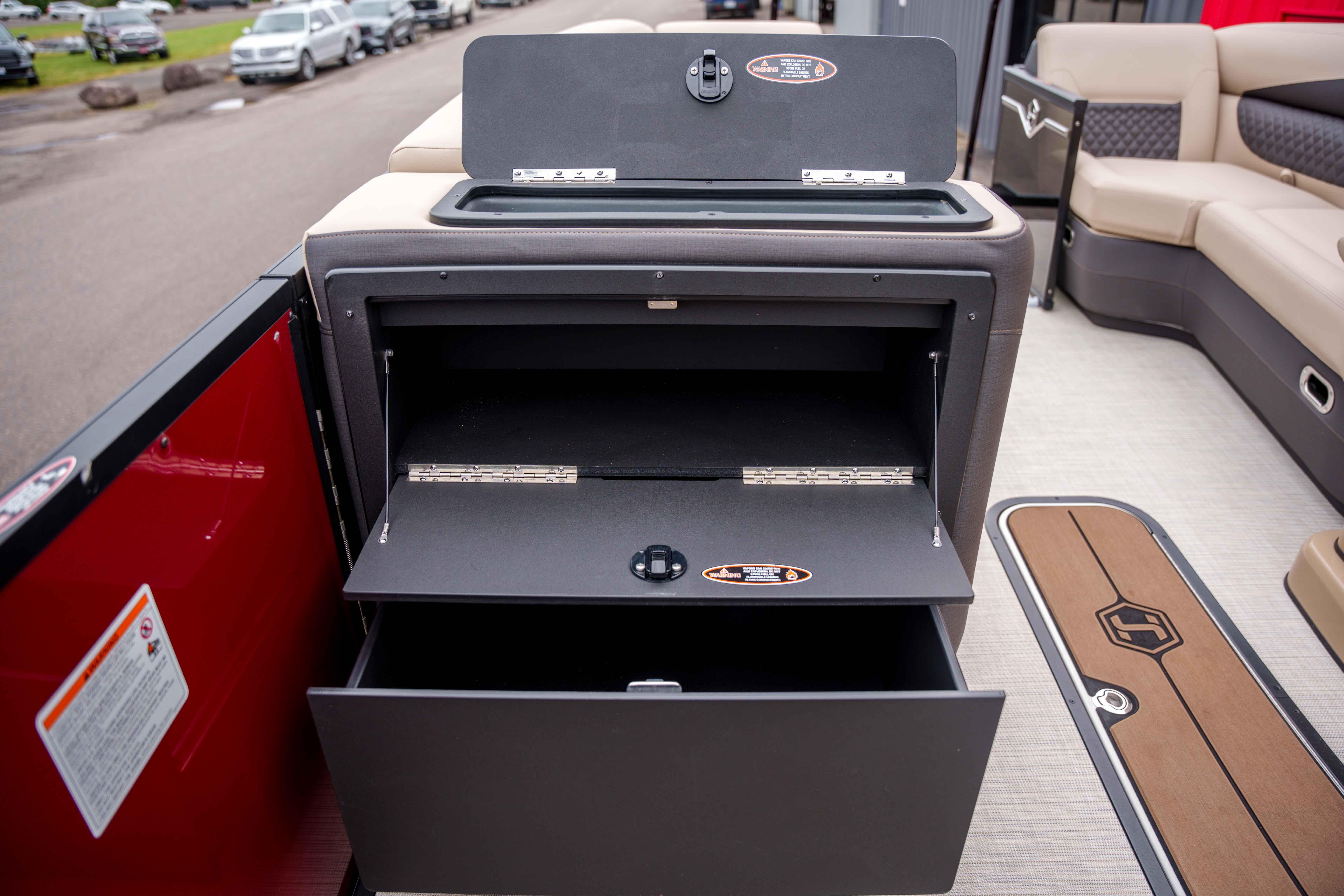 2026 Harris Sunliner 230 boat interior with open storage compartments.