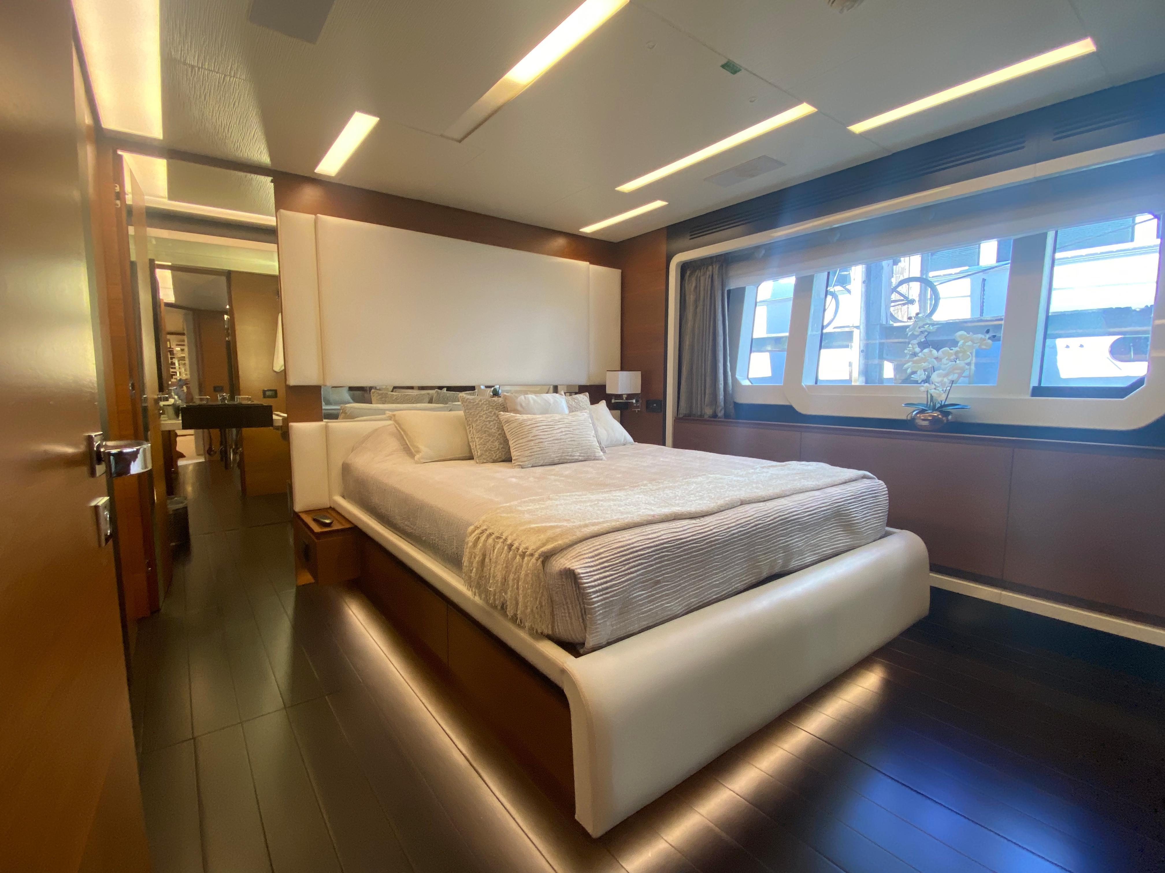 Luxurious bedroom interior of 2014 Azimut 100 Grande yacht with modern design.