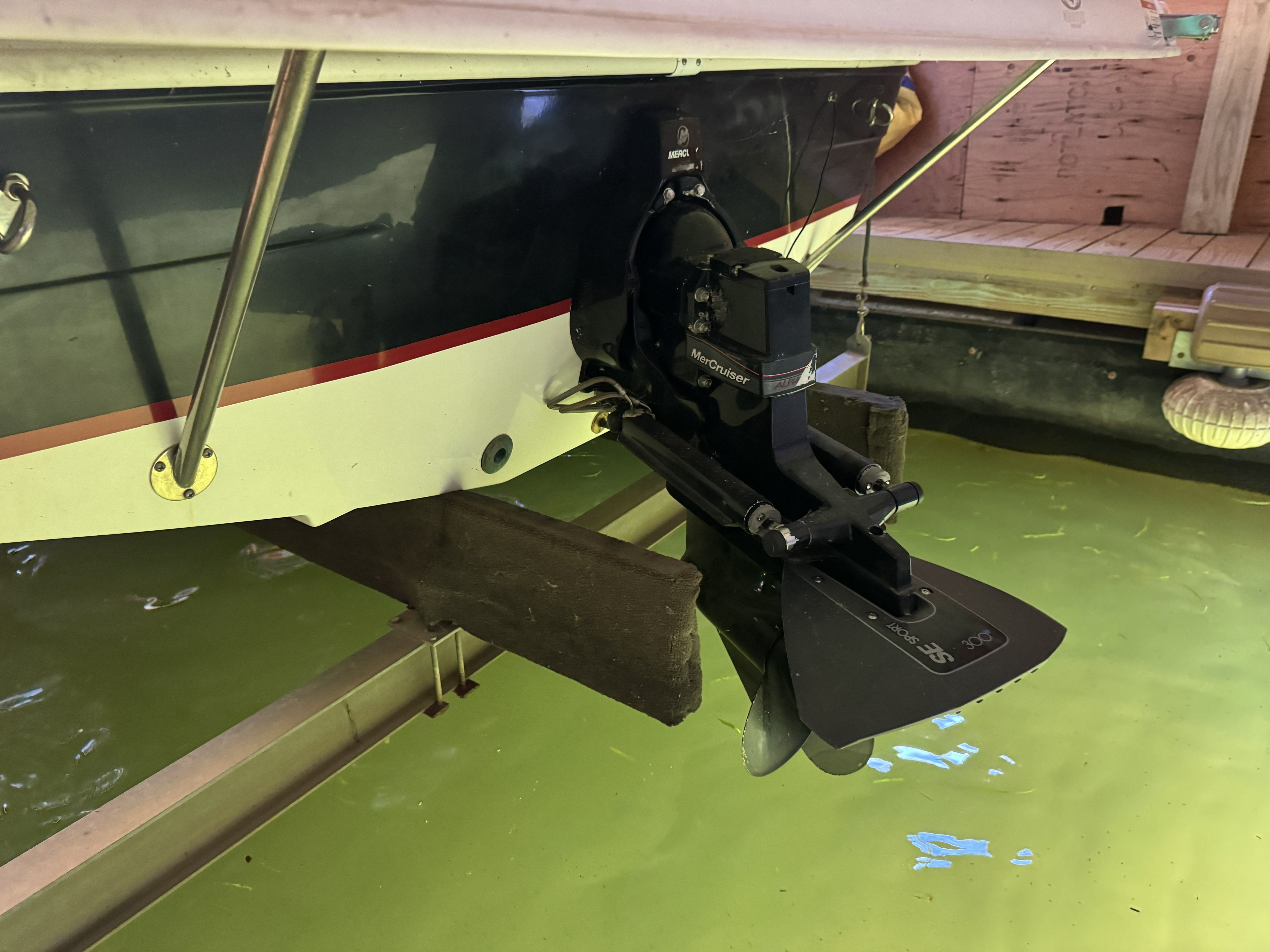 A 2014 Hurricane SS201 I/O is in the water, with an outboard motor visible.