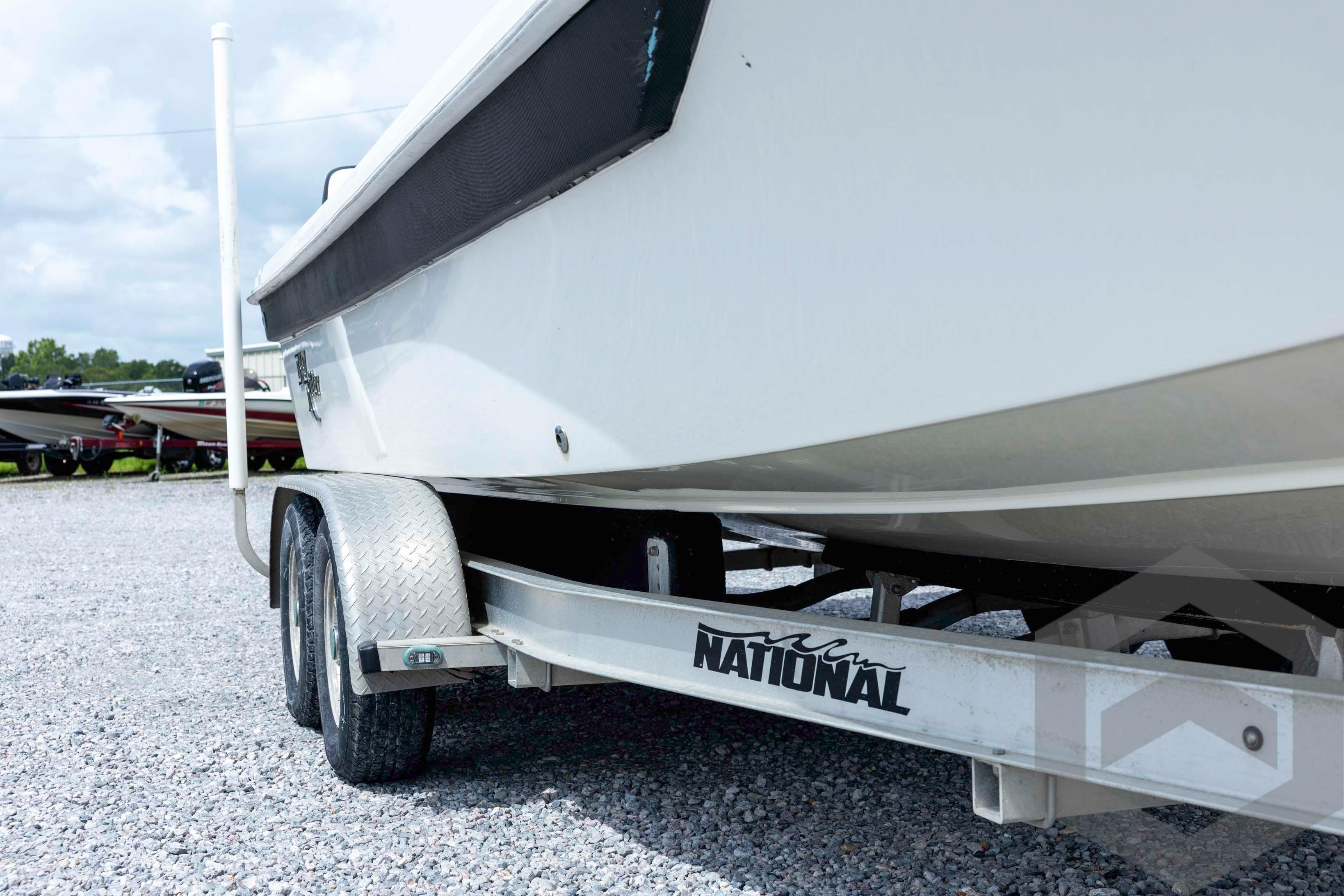 2018 Bay Rider 238 Bay boat on a National trailer, parked on gravel.