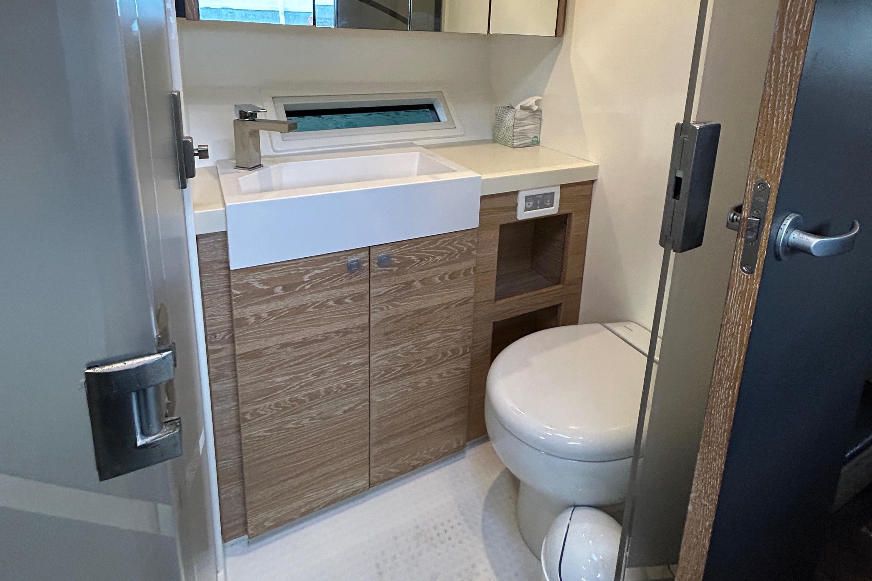 Luxurious bathroom in 2019 Xquisite Yachts X5, featuring modern sink and toilet.
