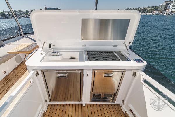 2025 Sunseeker Manhattan 68 yacht outdoor kitchen with grill and sink.