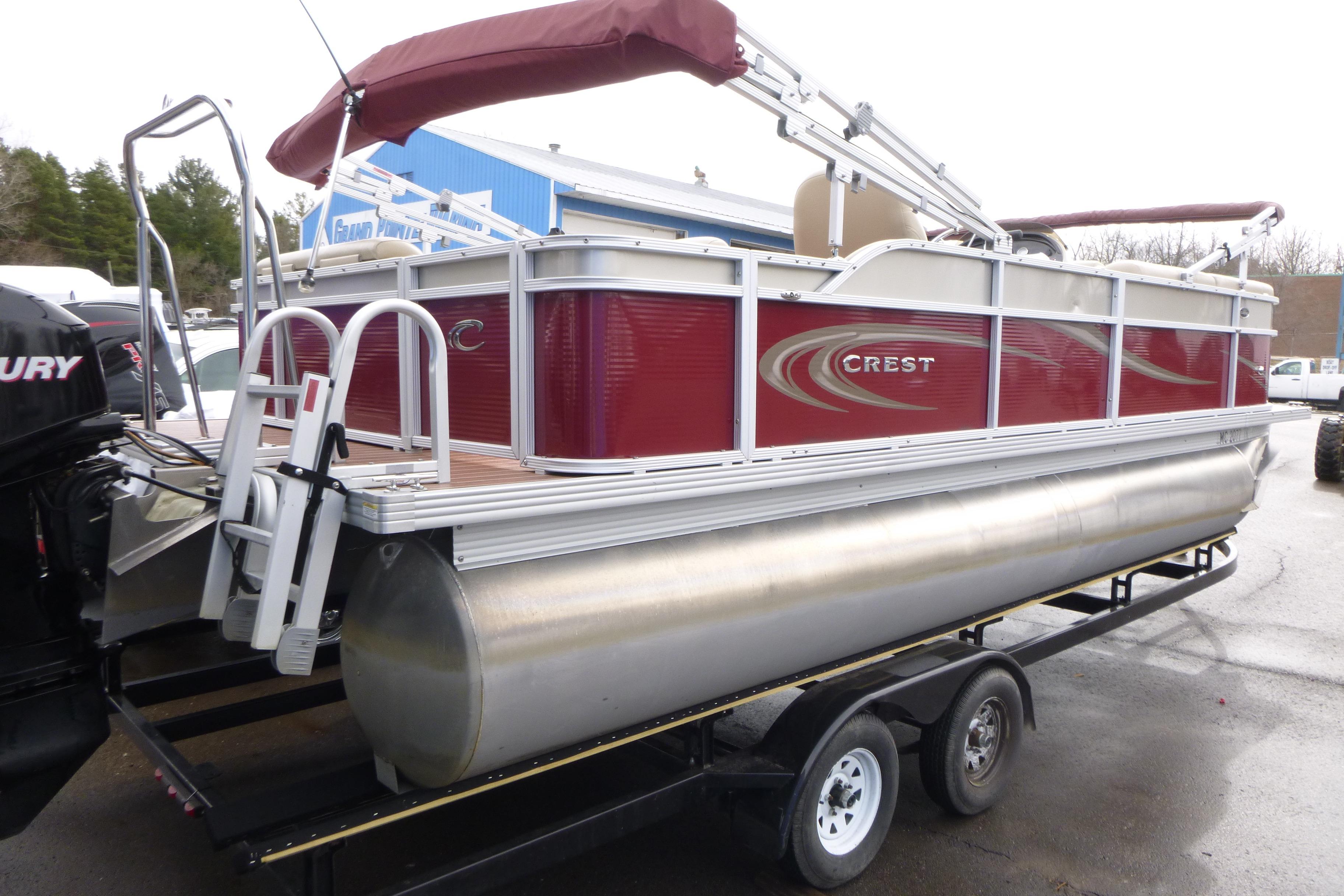 2012 Crest 230SLR Classic pontoon boat on trailer, featuring red and silver design.
