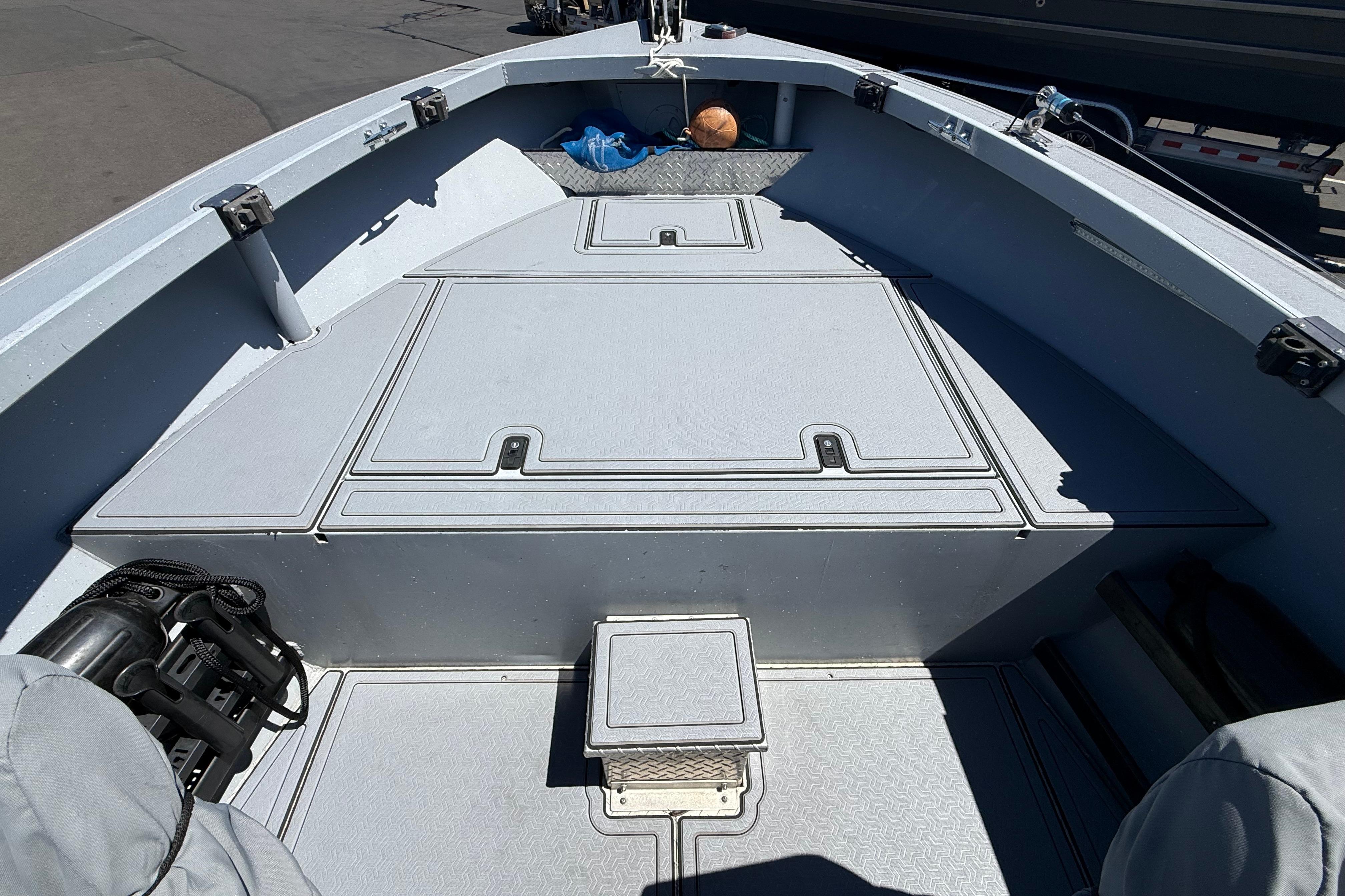 2015 Alumaweld Pacific XD 28 boat interior with storage compartments and seating area.