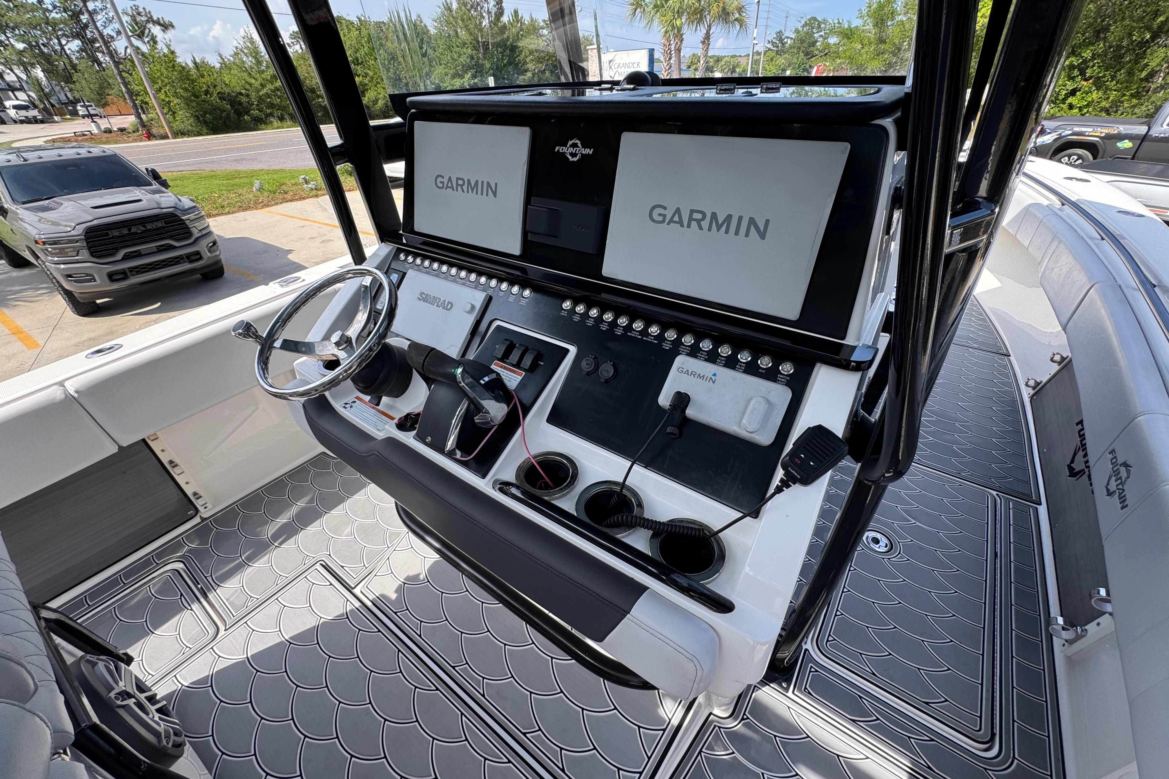 2023 Fountain 34 Tournament Edition boat dashboard with Garmin navigation system and steering wheel.
