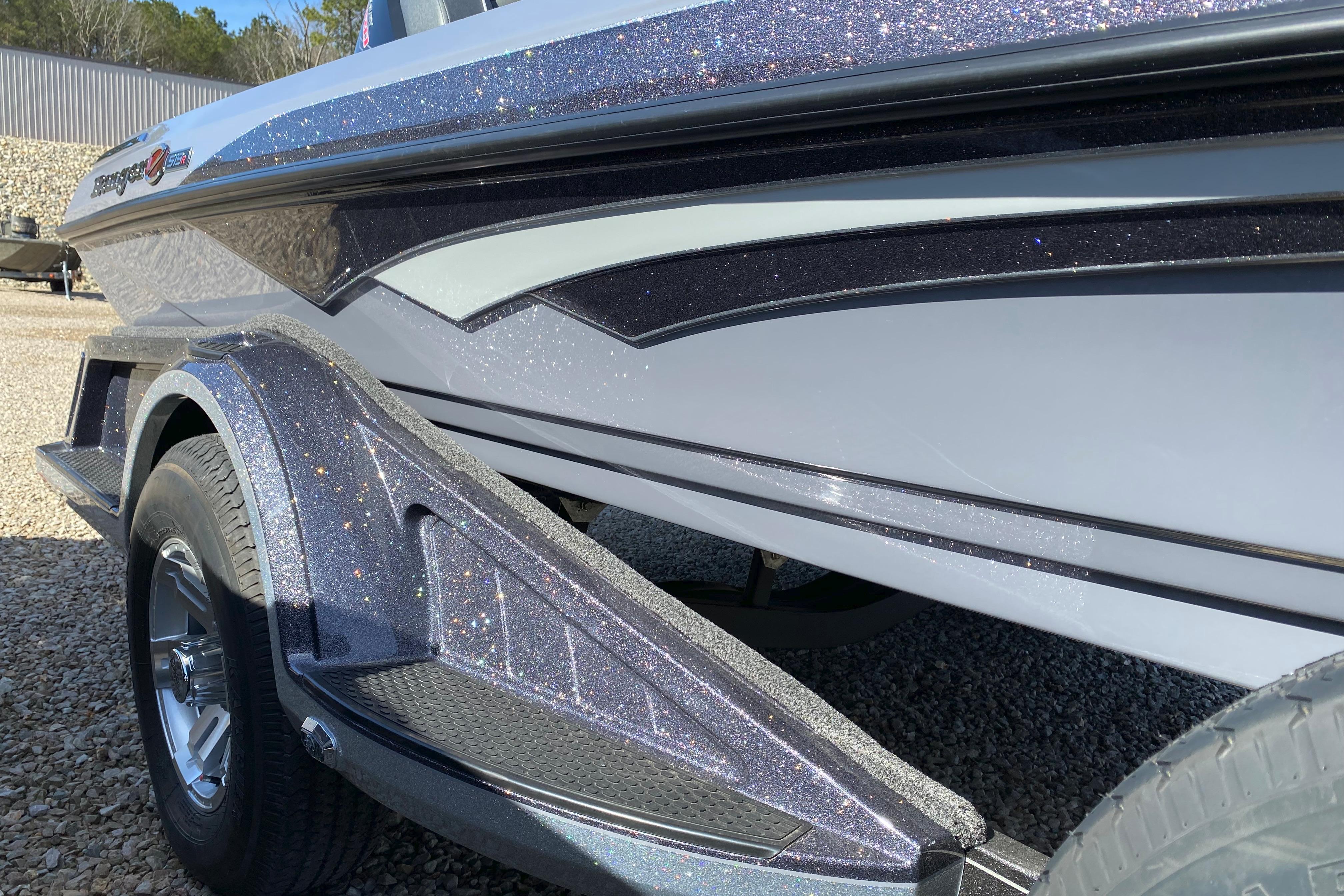 2026 Ranger Z519R boat with glittery finish on a trailer, parked on gravel.