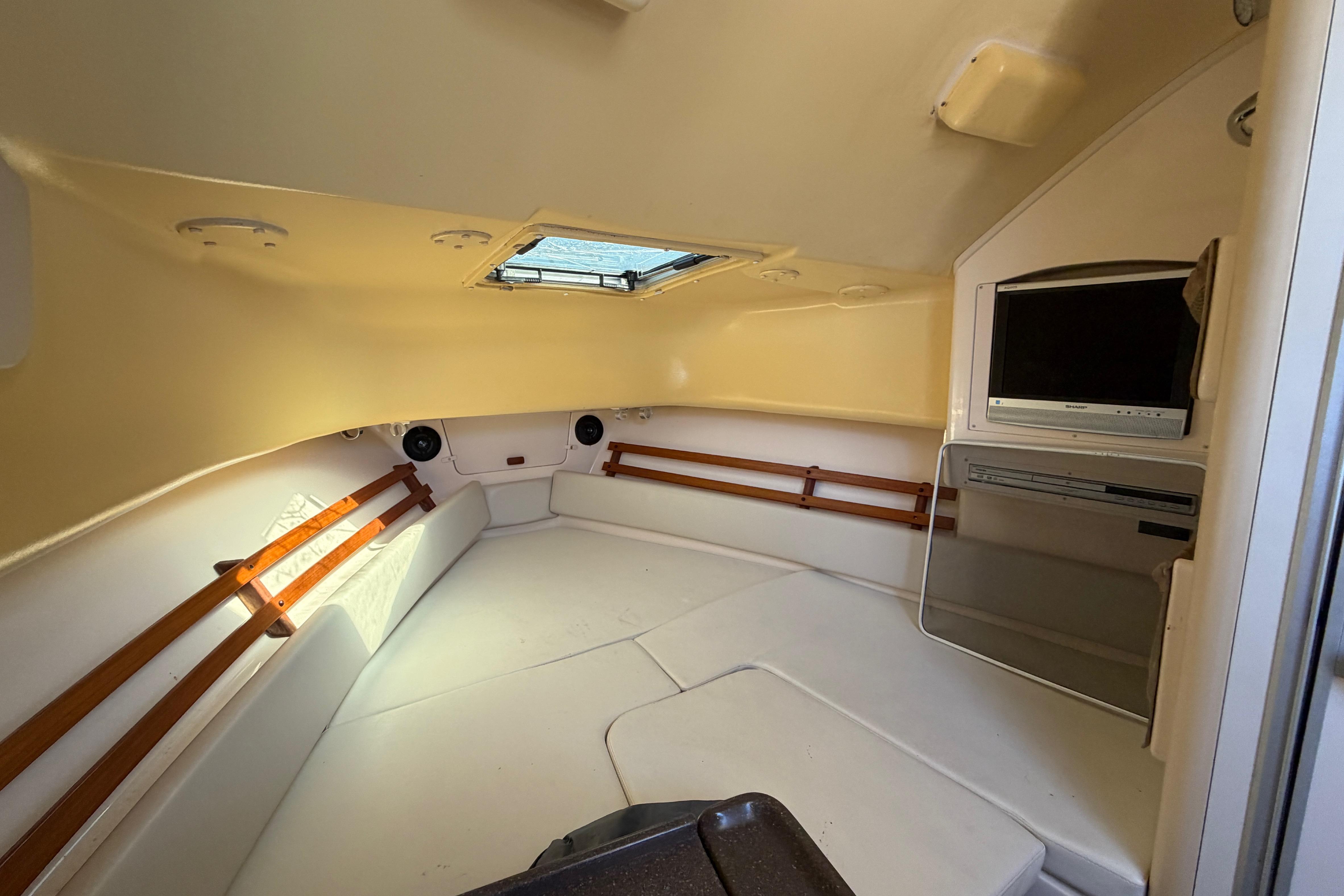 2006 Grady-White Sailfish 282 cabin interior with TV and skylight.
