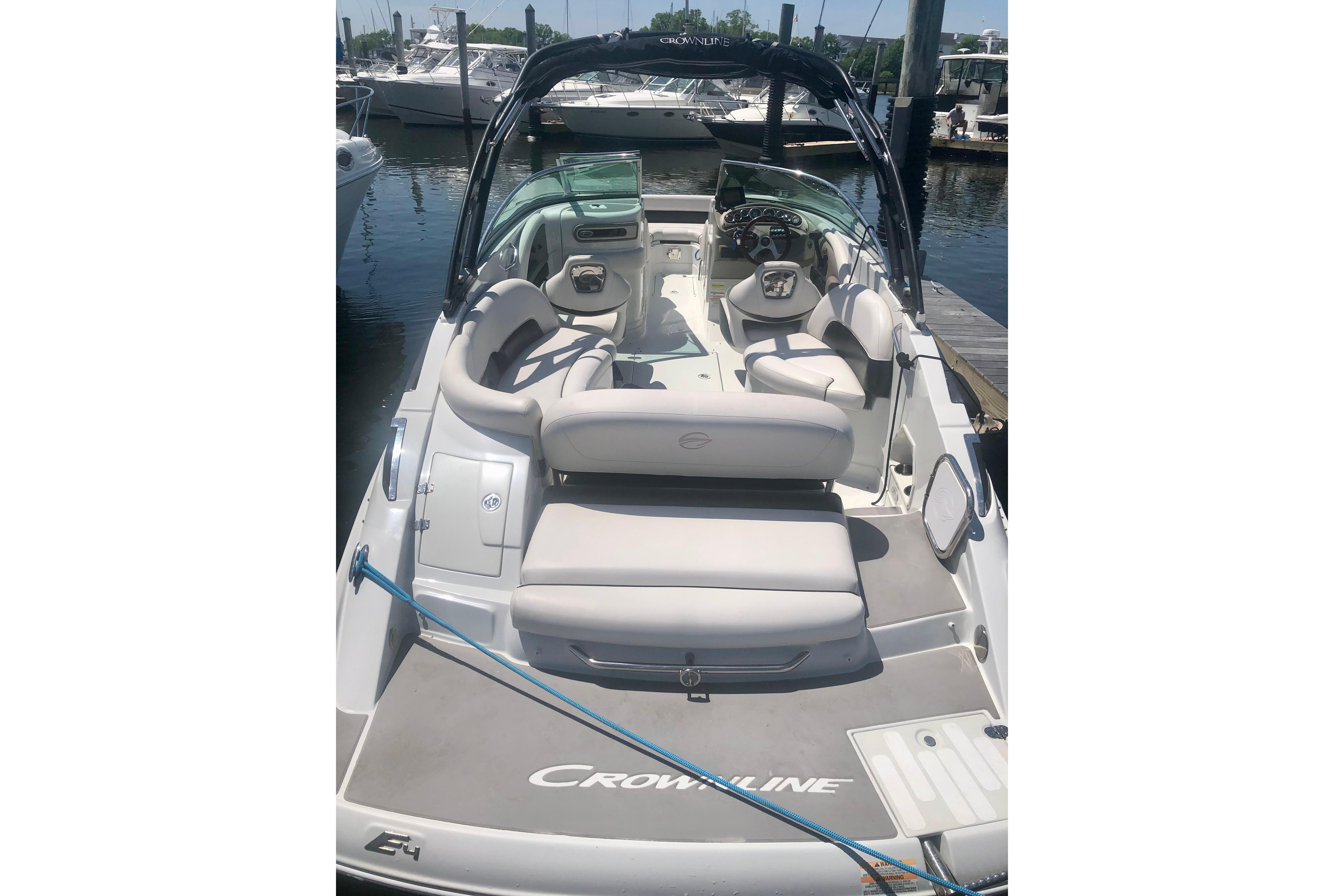 2013 Crownline Eclipse E4 boat docked, featuring spacious seating and sleek design.