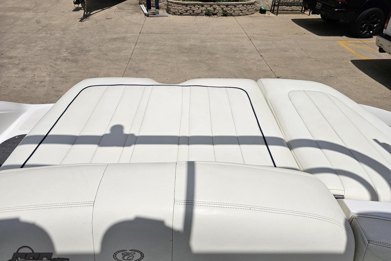 White leather seating on a 2010 Cobalt 232 WSS boat, parked on concrete.